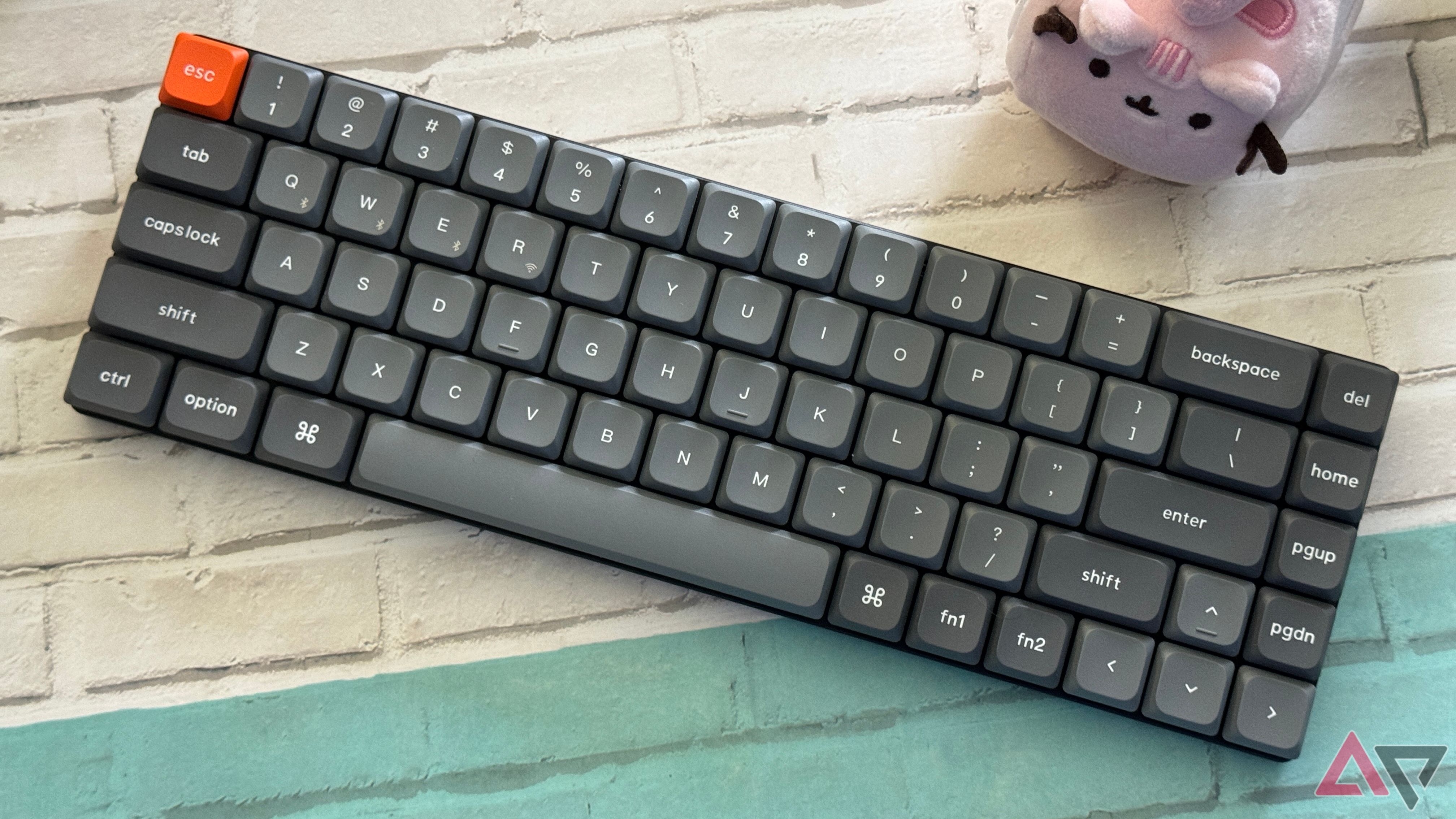 Keychron K7 Max sideways on a desk with a Pusheen