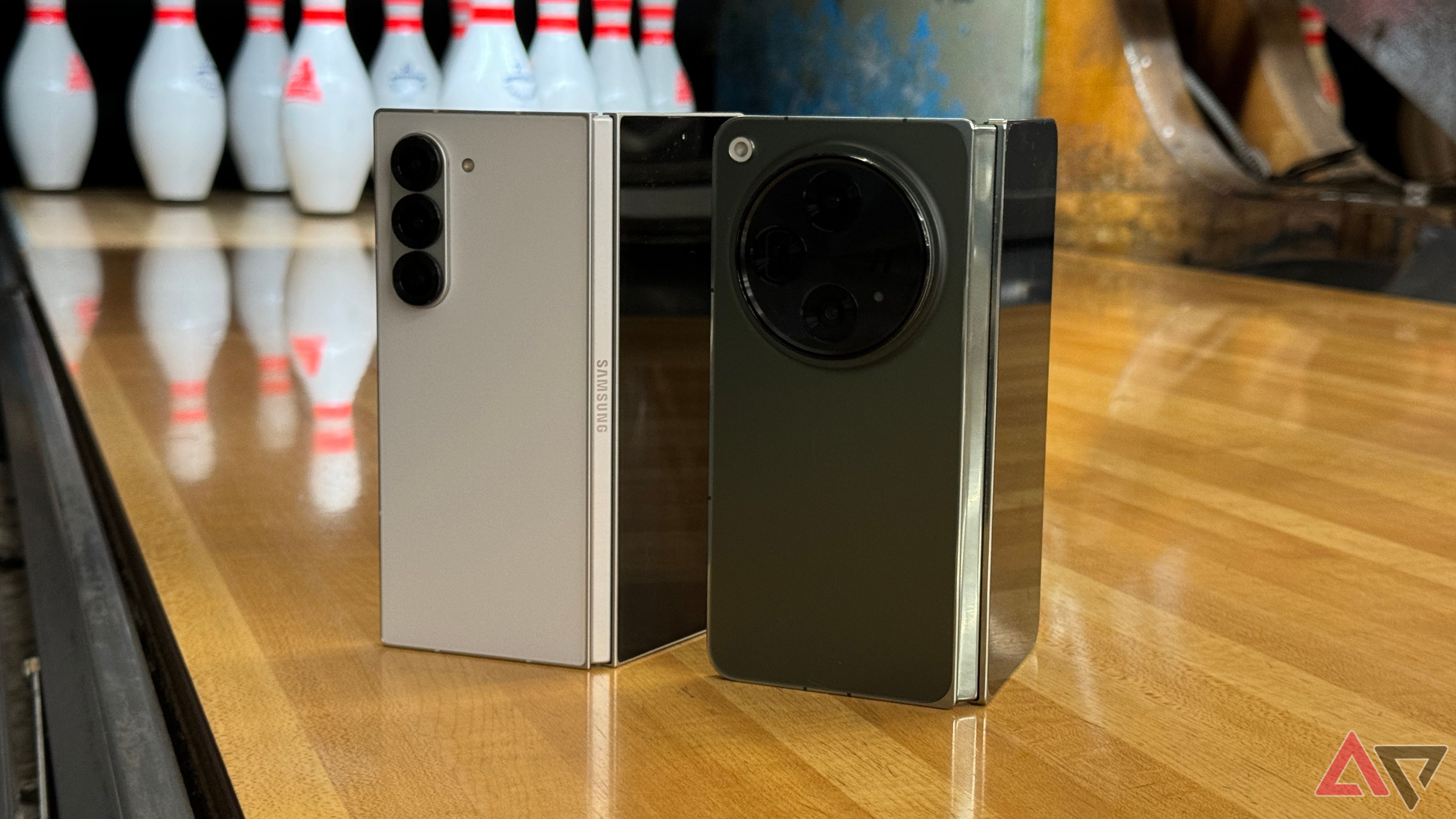 Samsung Galaxy Z Fold 6 and OnePlus Open standing in front of bowling pins