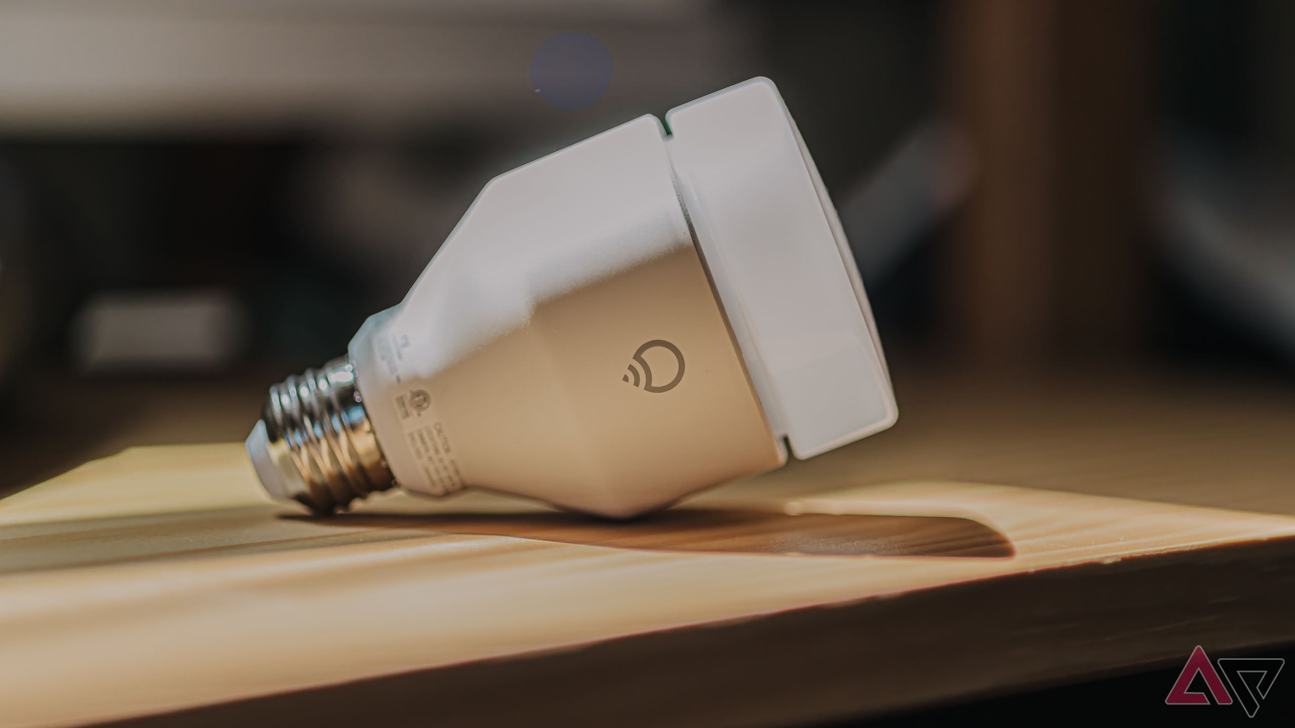 LIFX A21 SuperColor Smart Bulb on its side on wooden desk