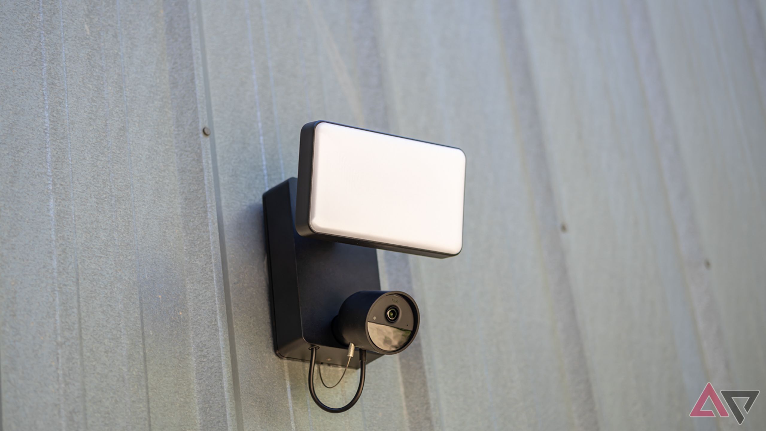 Philips Hue Secure Floodlight Camera mounted on gray metal quonset