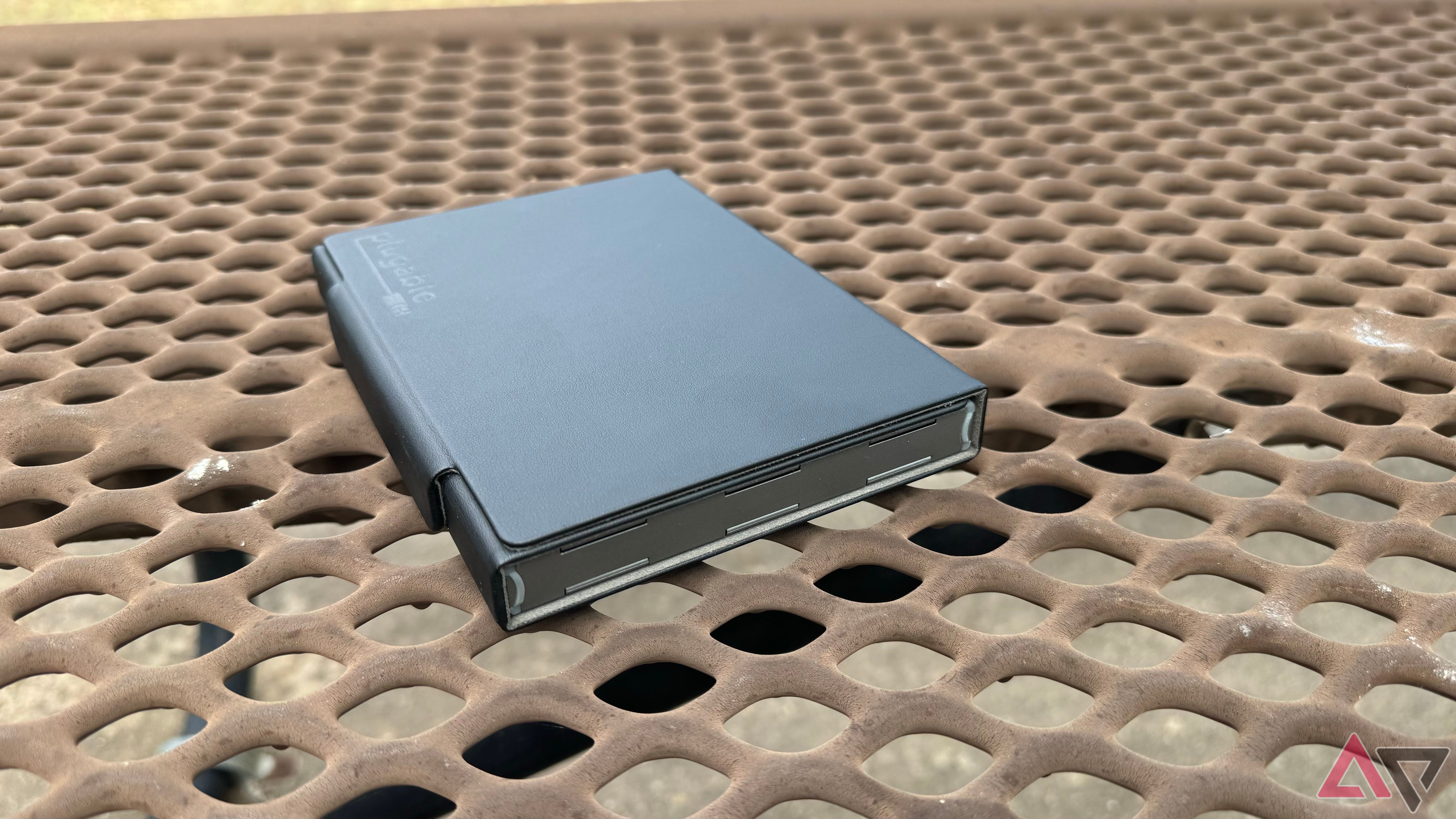 Plugable Foldable Bluetooth Keyboard looks like a book in its carrying case on a picnic table