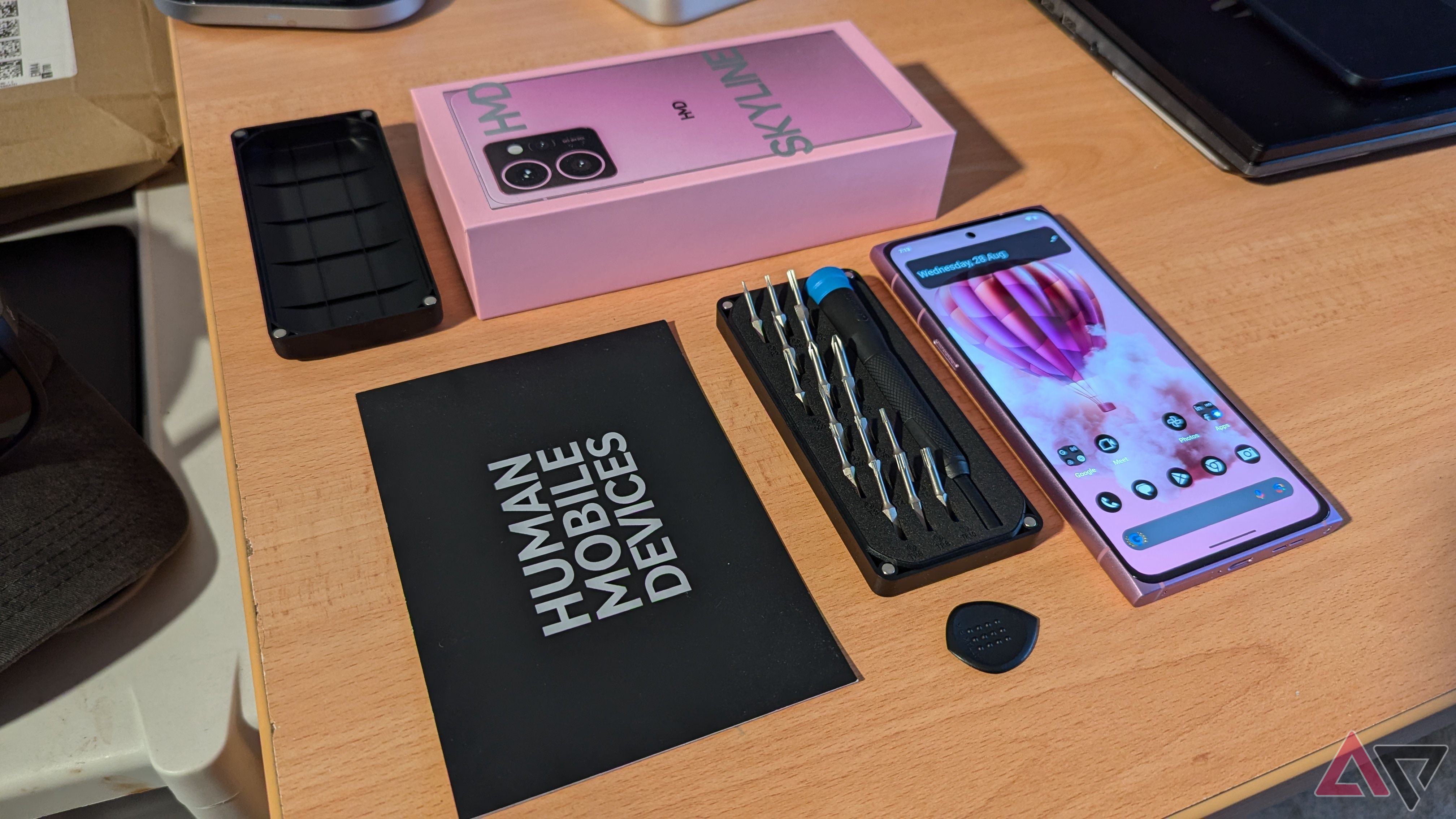 HMD Skyline and iFixit tool kit on desk table with HMD Skyline packaging