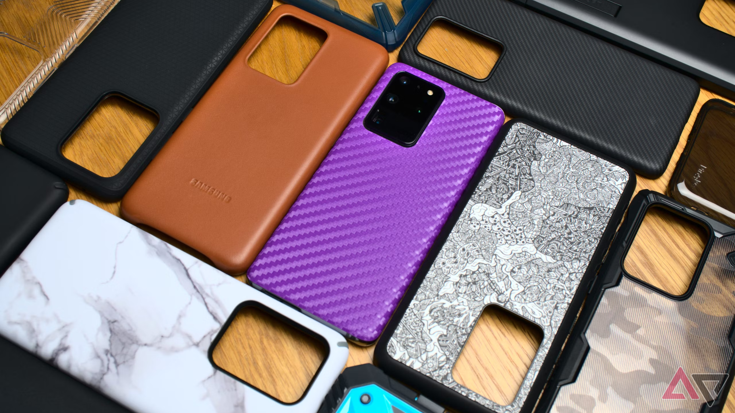 A Galaxy S20 Ultra surrounded by phone cases from various brands 