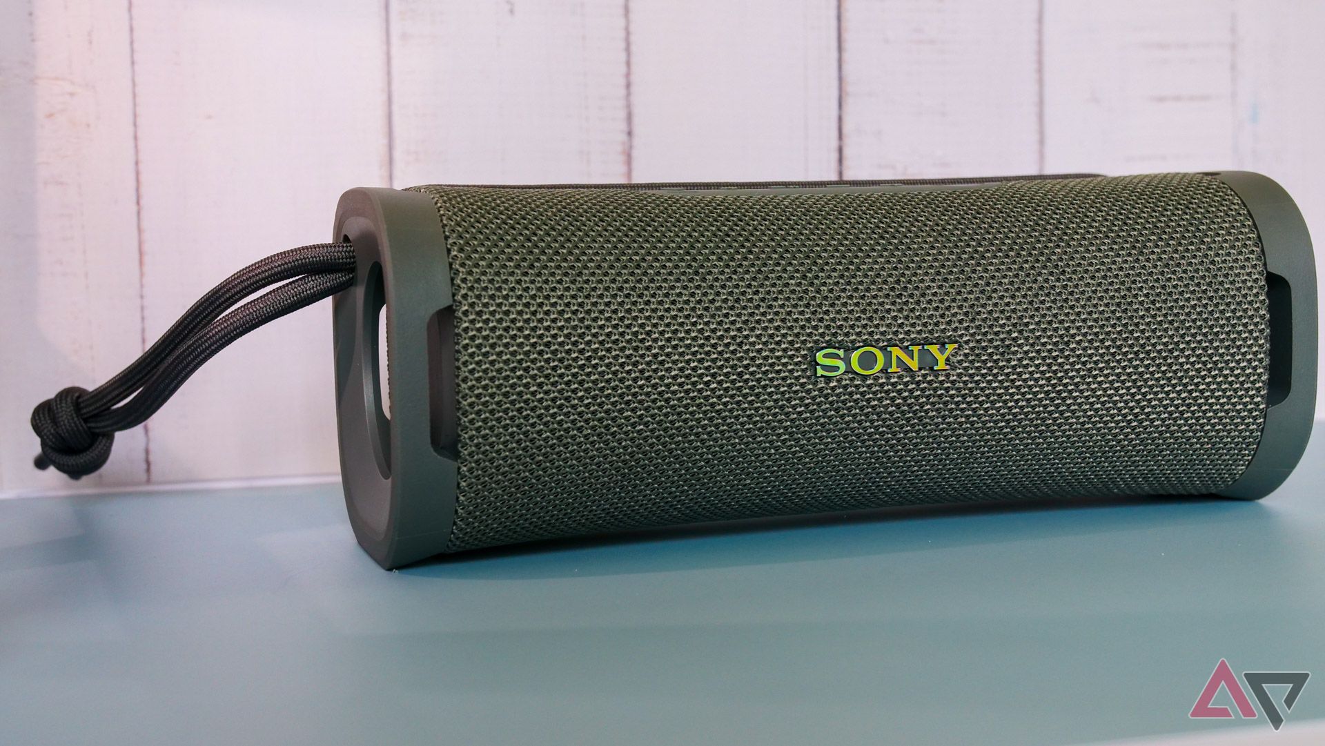 The Sony Ult Field 1 speaker in front of a white fence backdrop.