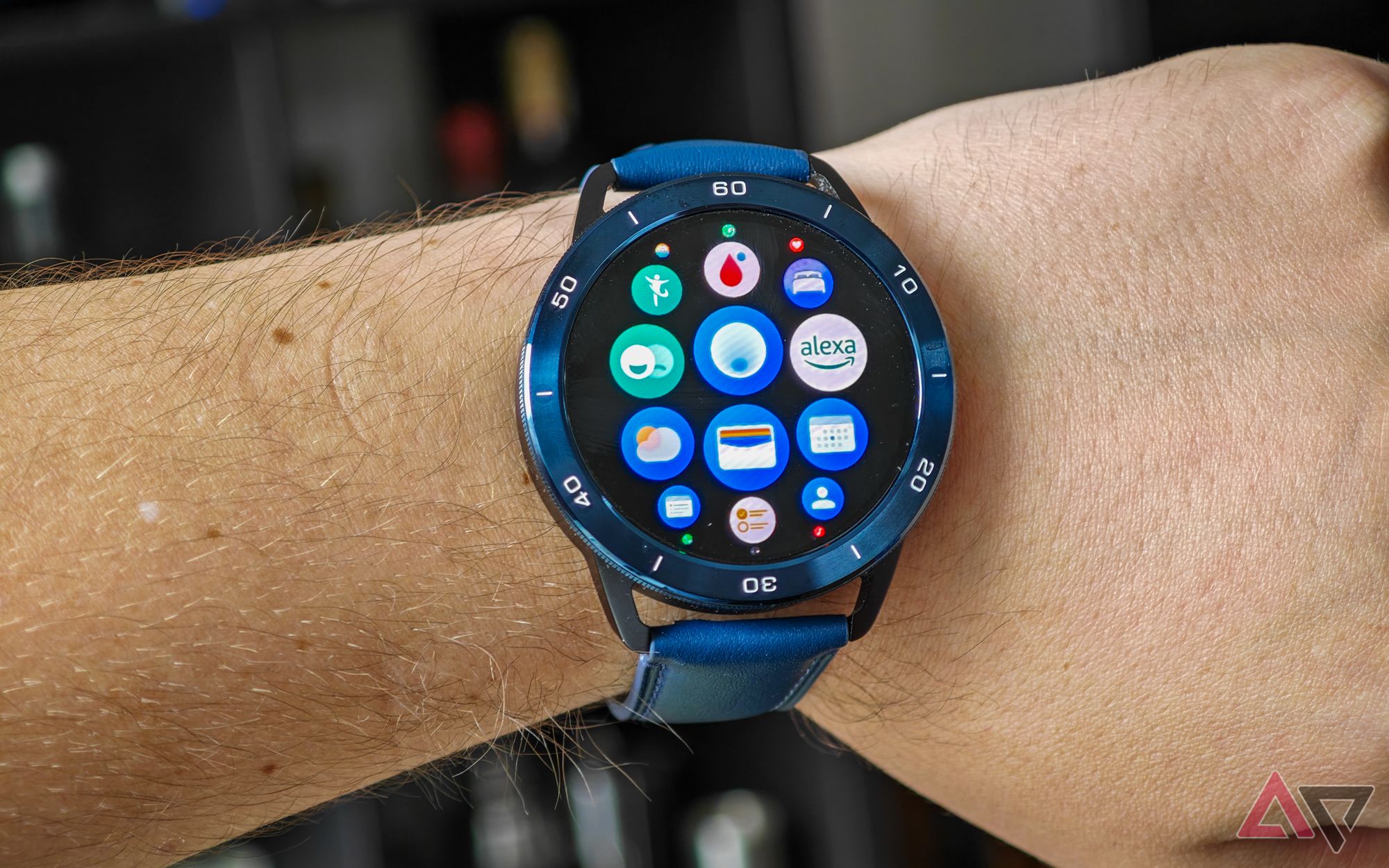 Xiaomi Watch S3 on a man's wrist showing a few apps including Alexa