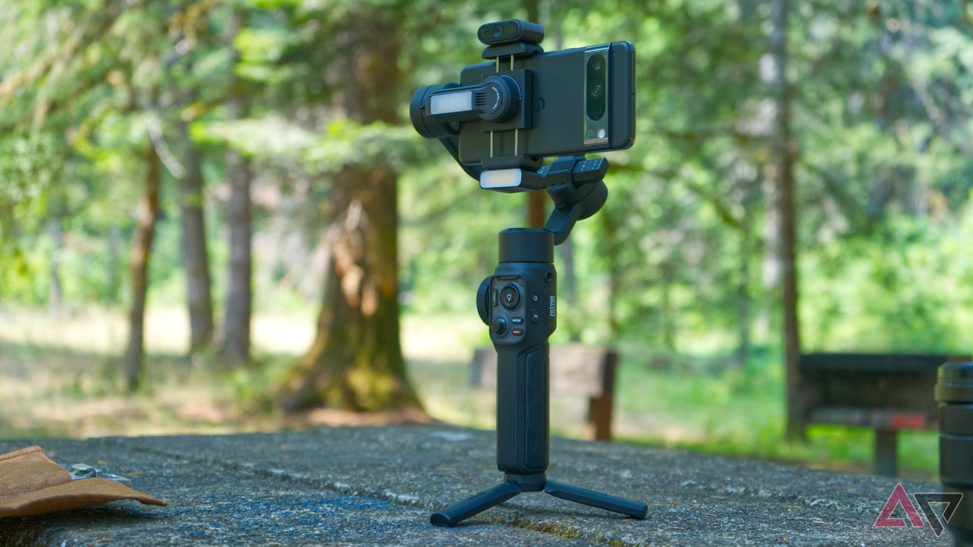 Zhiyun Smooth 5S AI standing upright with both accessory modules attached, a forest in the background