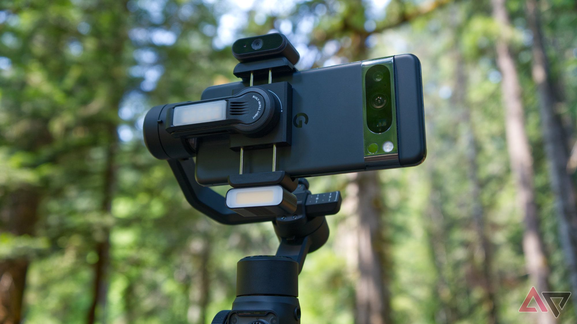 Zhiyun Smooth 5S AI with motion tracking and fill light dongles attached with a forest background