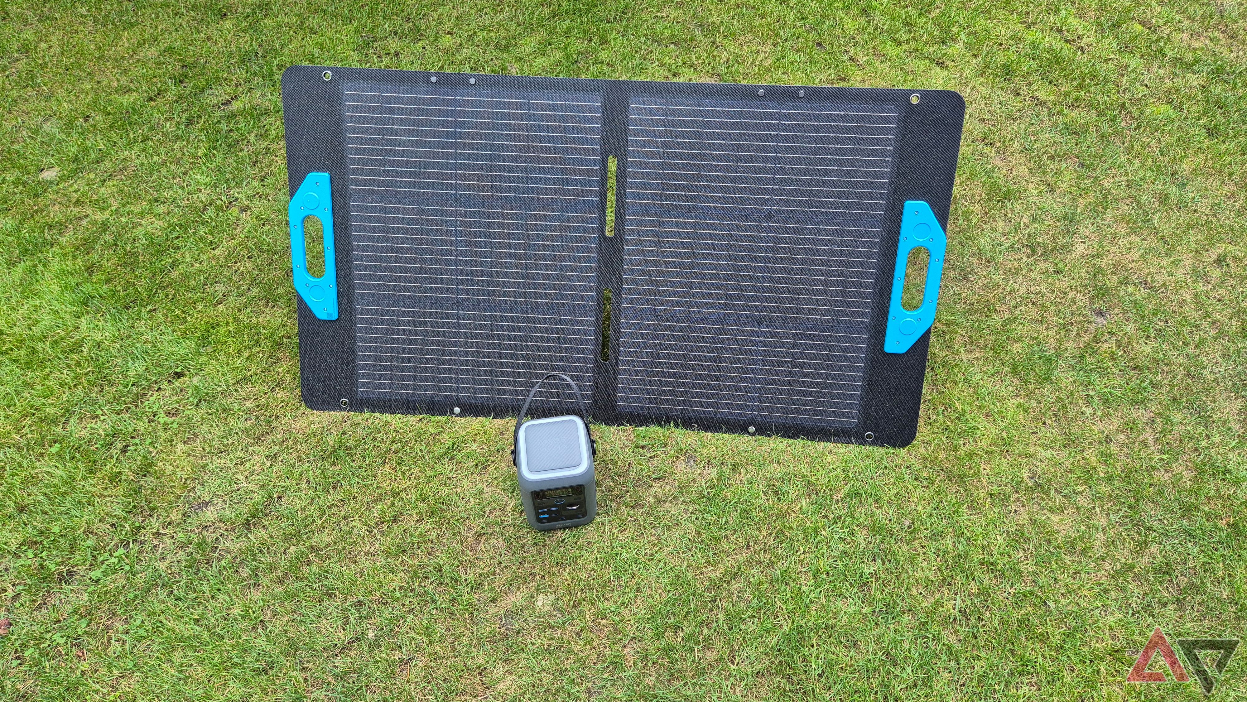 Anker C300 DC next to an open solar panel on the grass