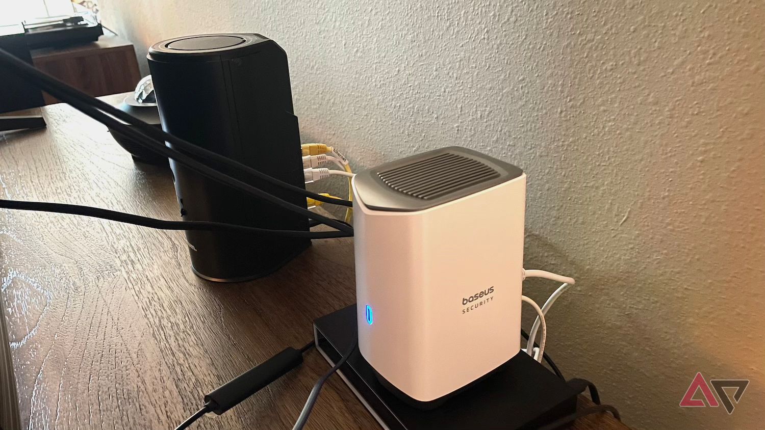 H1 Homstation of Baseus S1 Pro Outdoor Security Camera next to the router