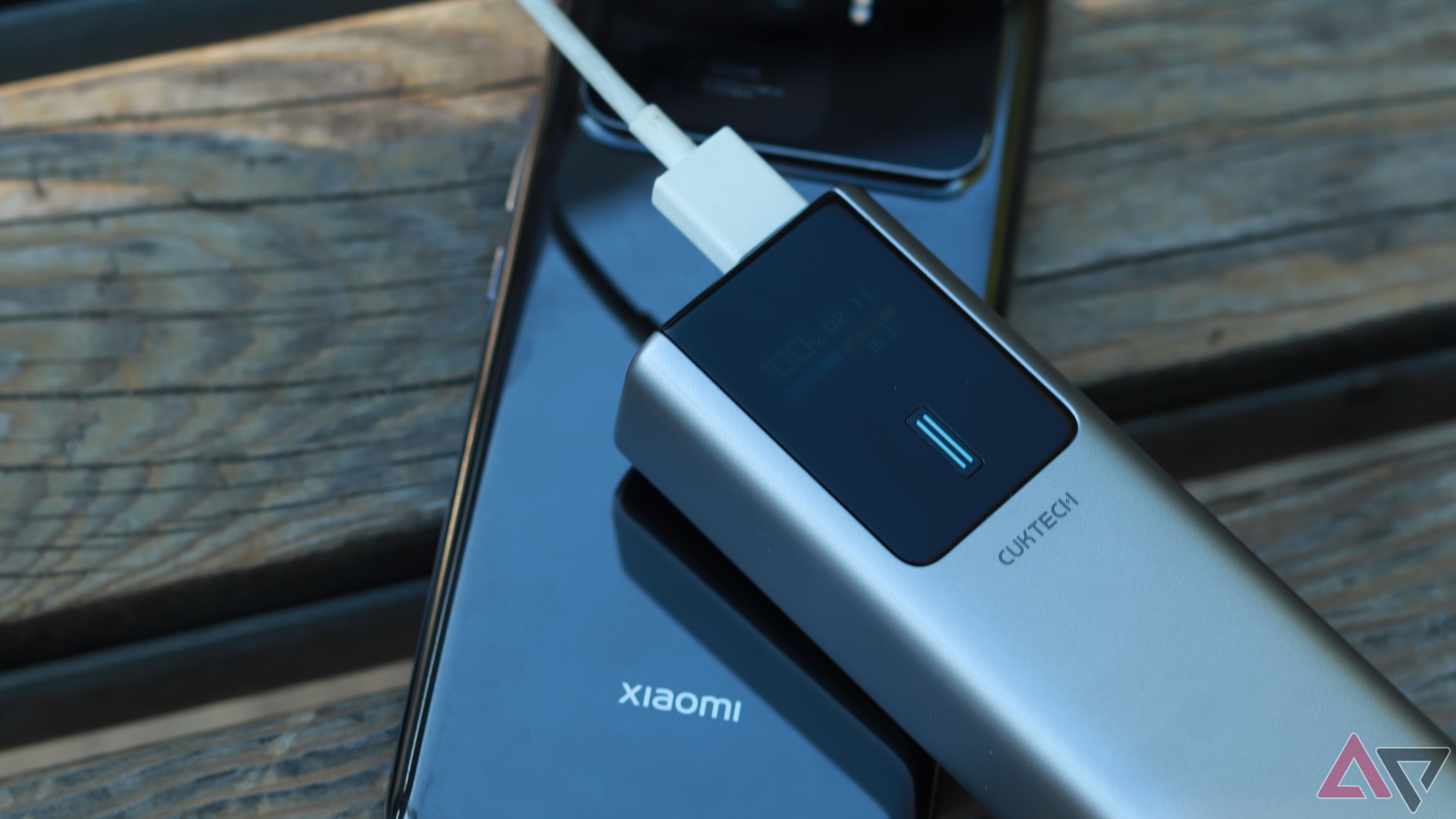 Cuktech 10 Power Bank Outdoors on a wooden surface