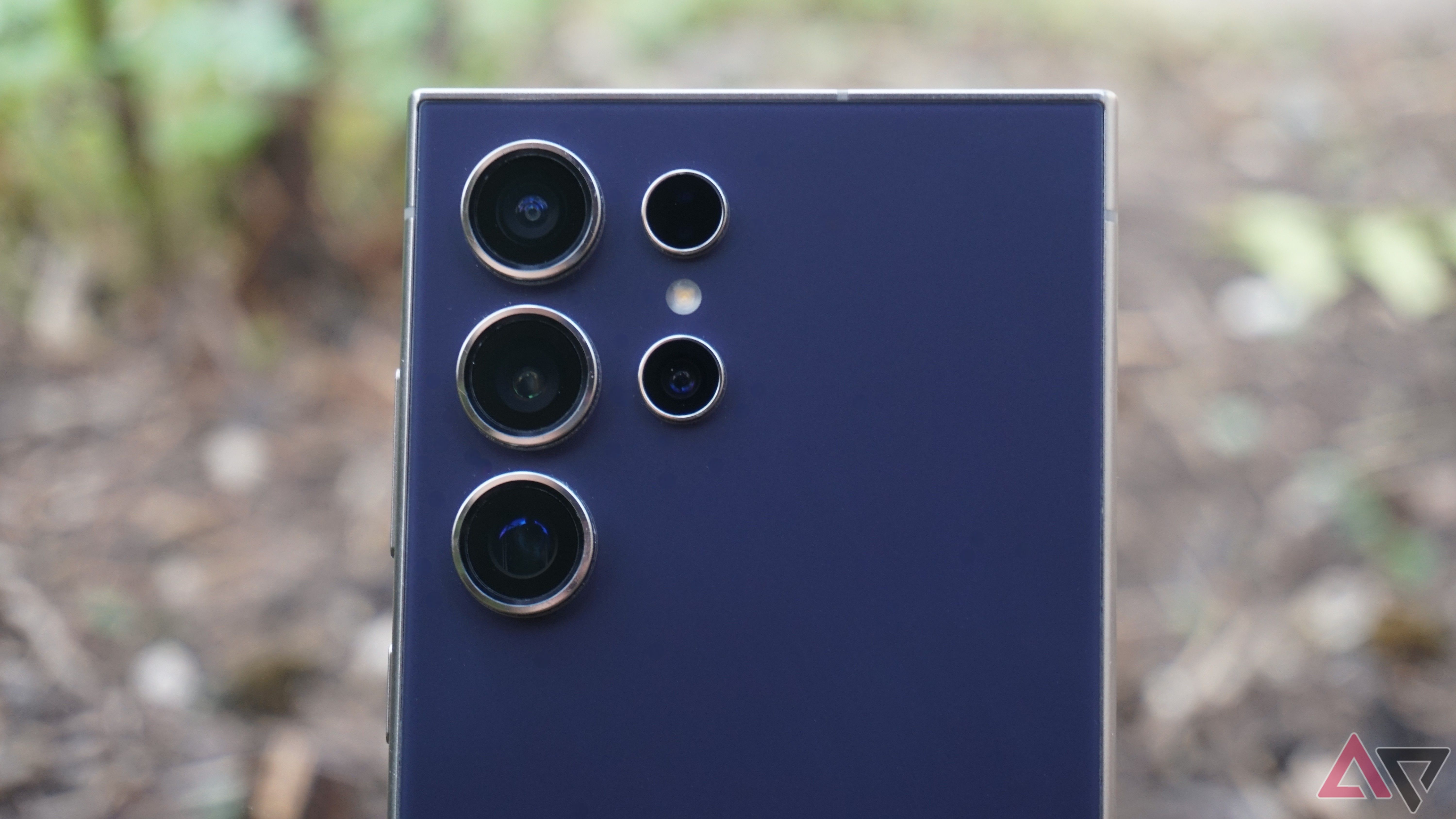 A close up of the camera on a purple Samsung Galaxy S24 Ultra