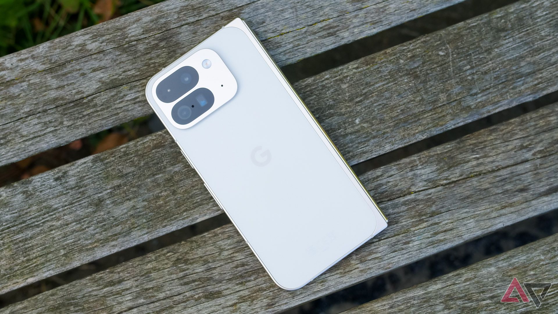 The Pixel 9 Pro Fold sitting face down on a park bench.