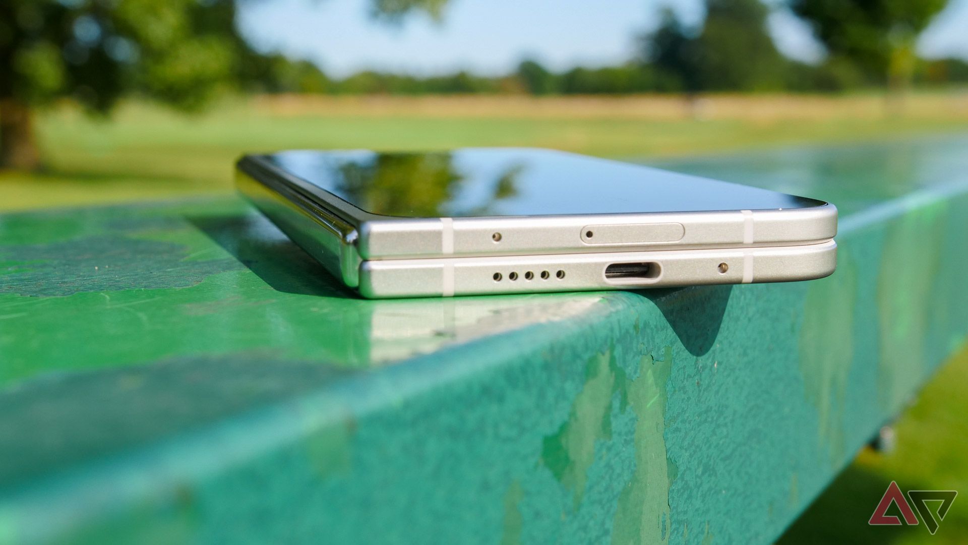 The Pixel 9 Pro Fold resting on a park bench with the charging port shown.