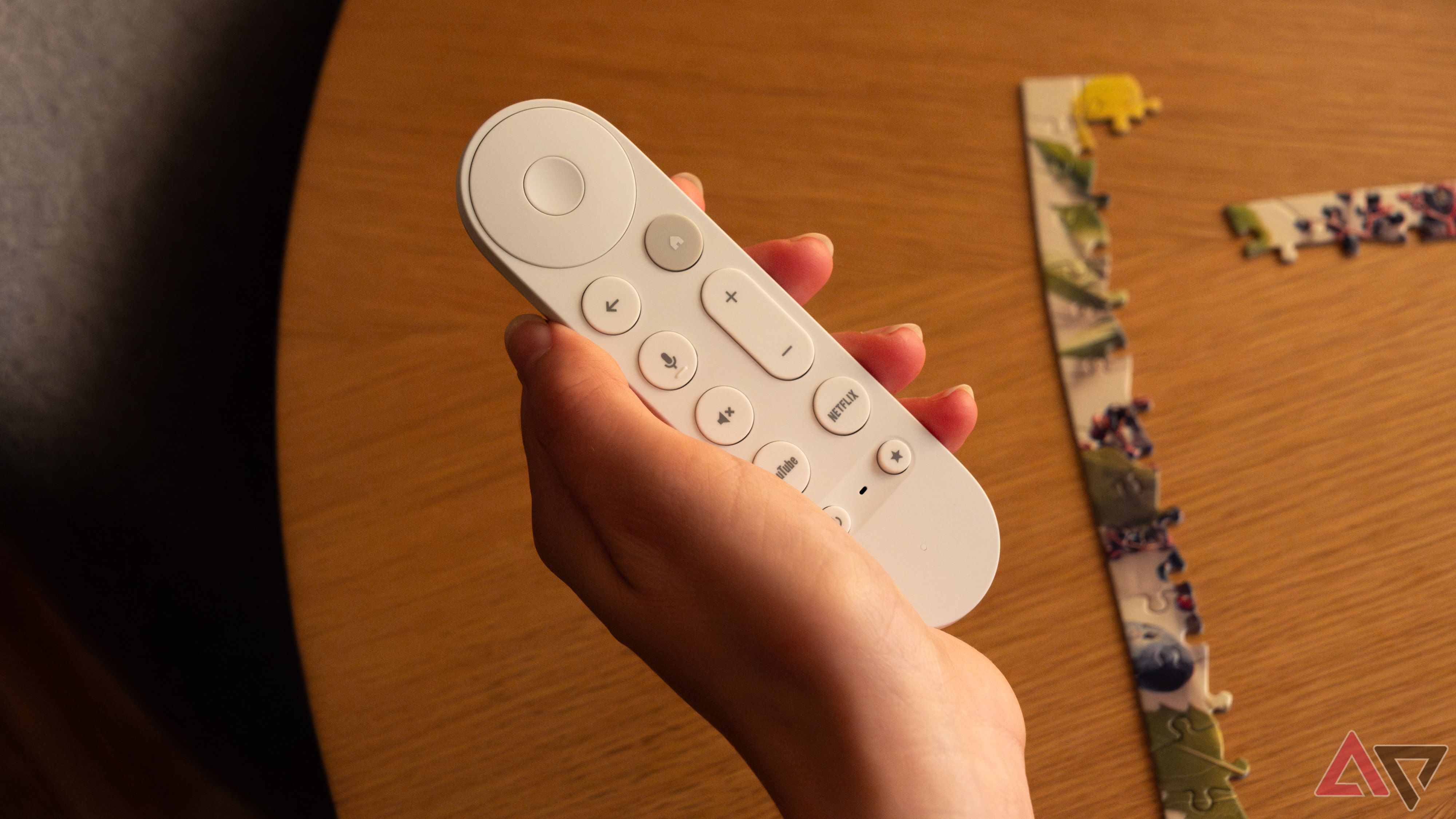 The Google TV Streamer remote in a woman's hand.