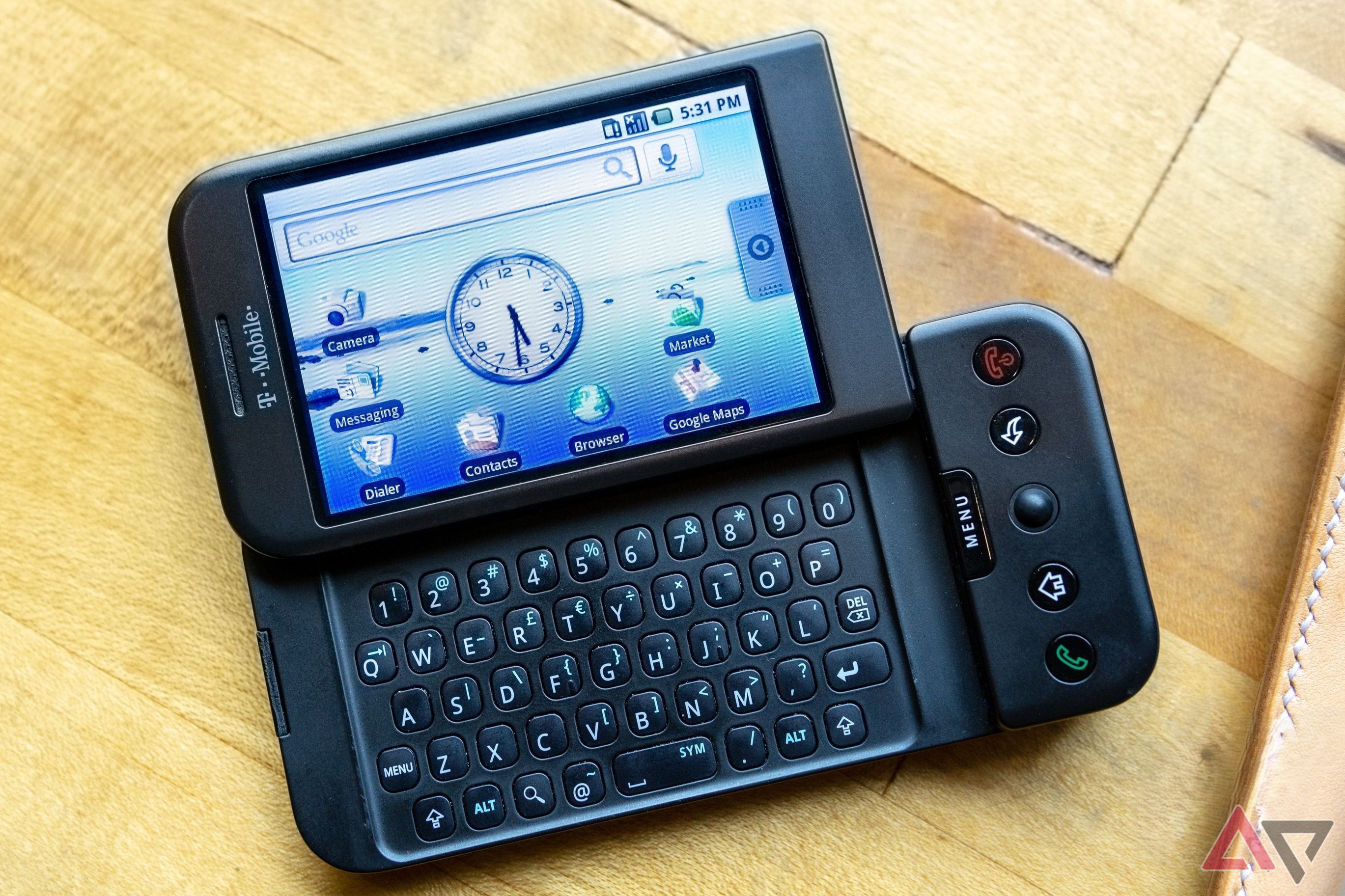 HTC Dream with screen open laying on desk