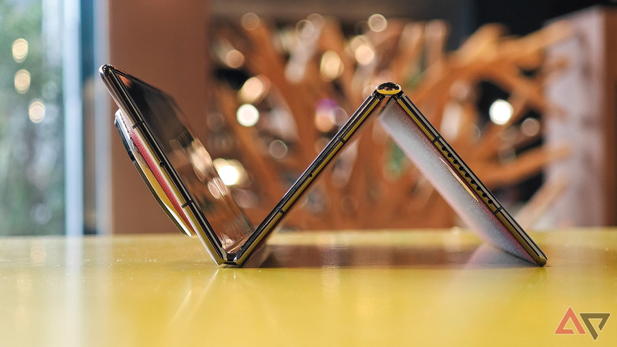 The Huawei Mate XT in a partially tri-folded position