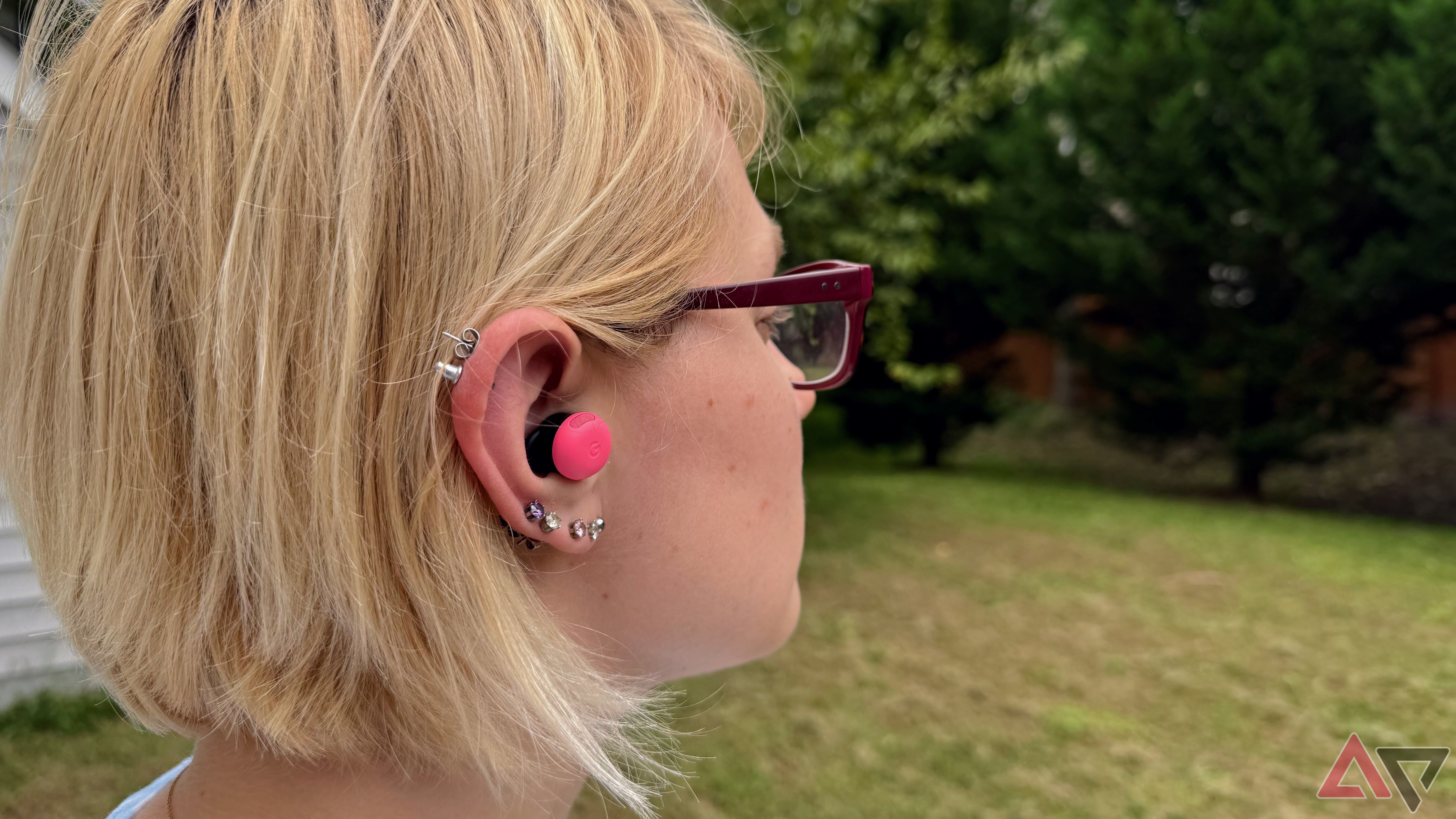 Women with earrings and glasses wearing Google Pixel Buds Pro 2