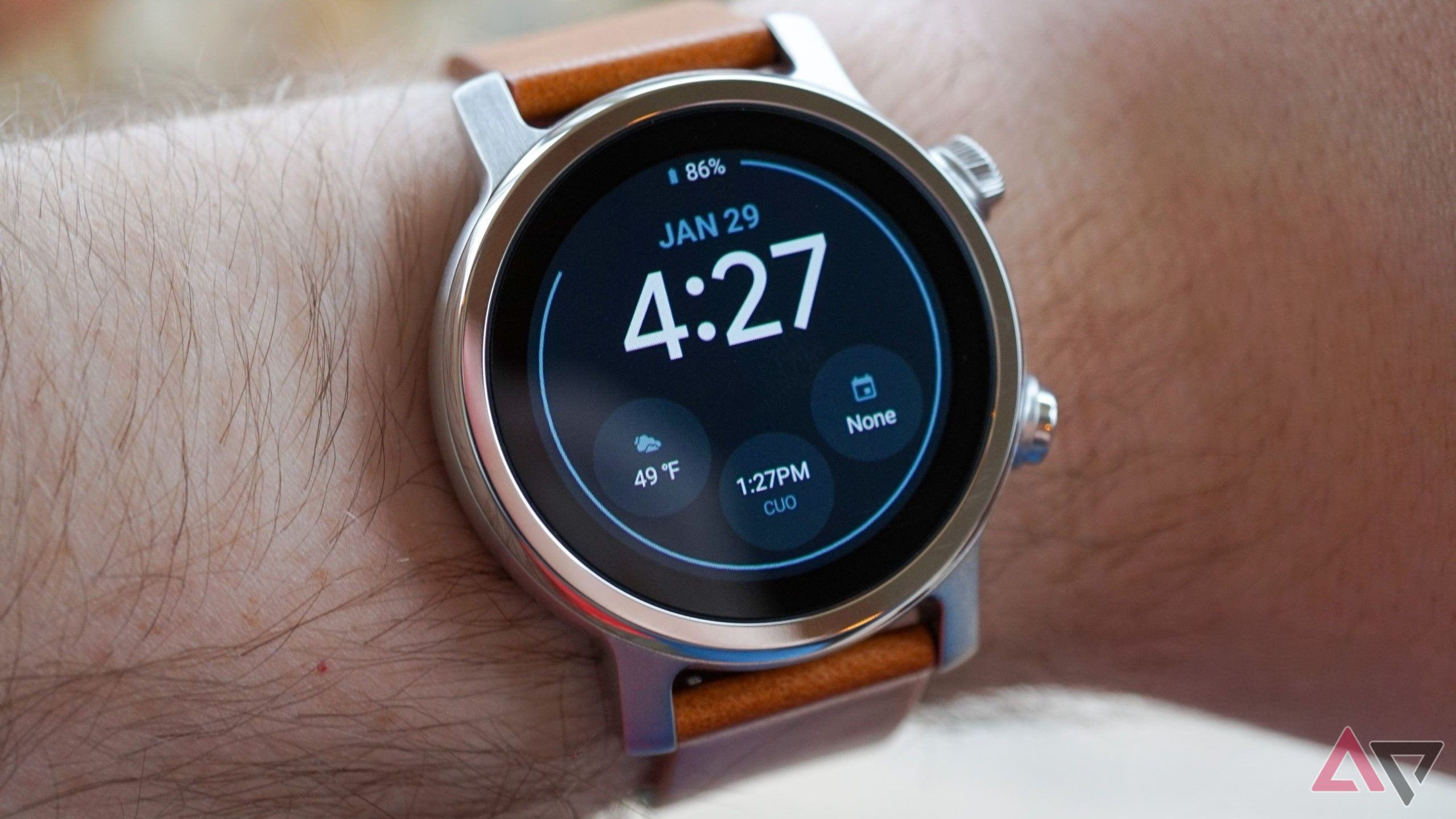 moto 360 on wrist with clock face showing