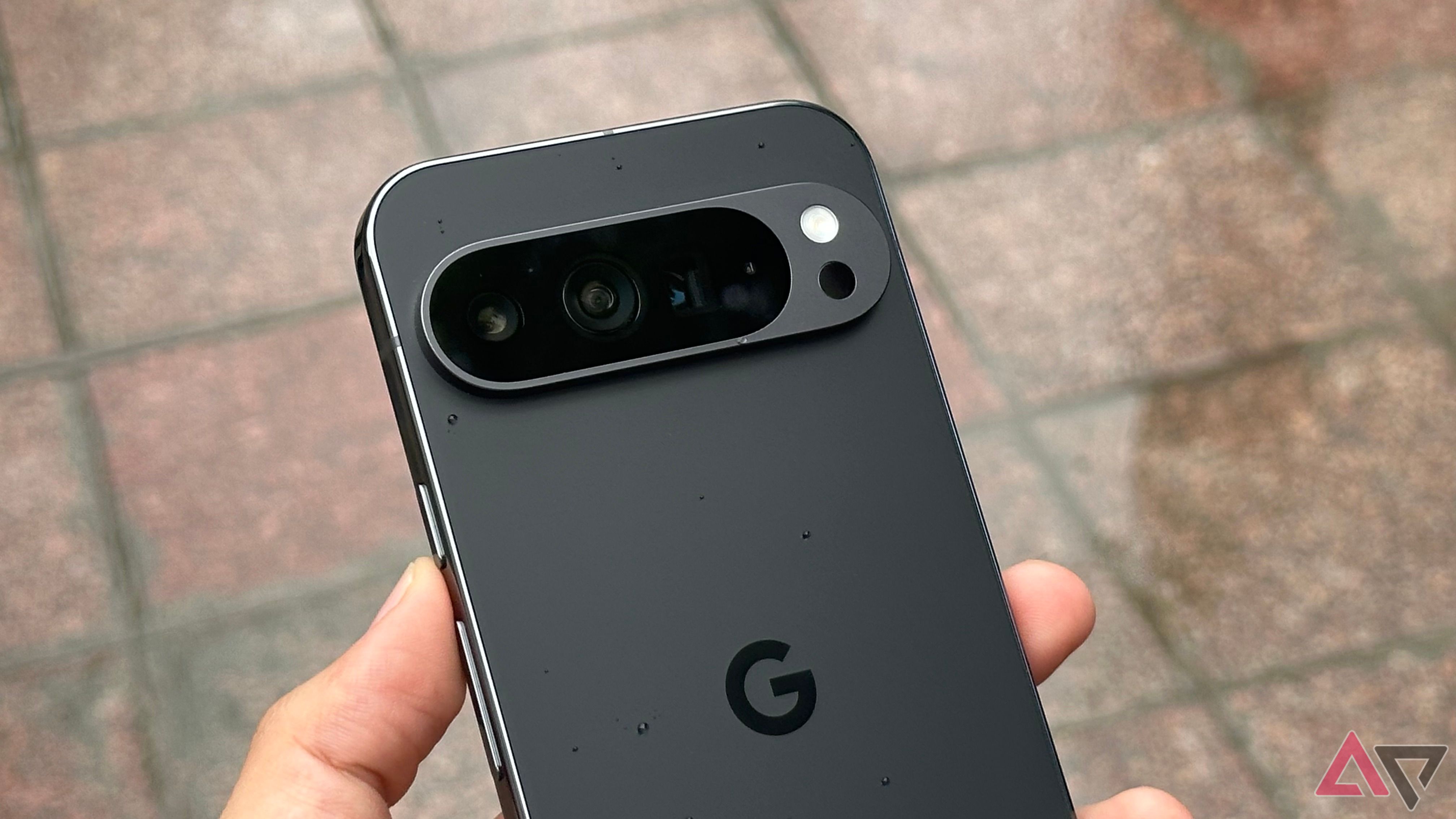 Google Pixel 9 Pro XL in hand with water droplets on top