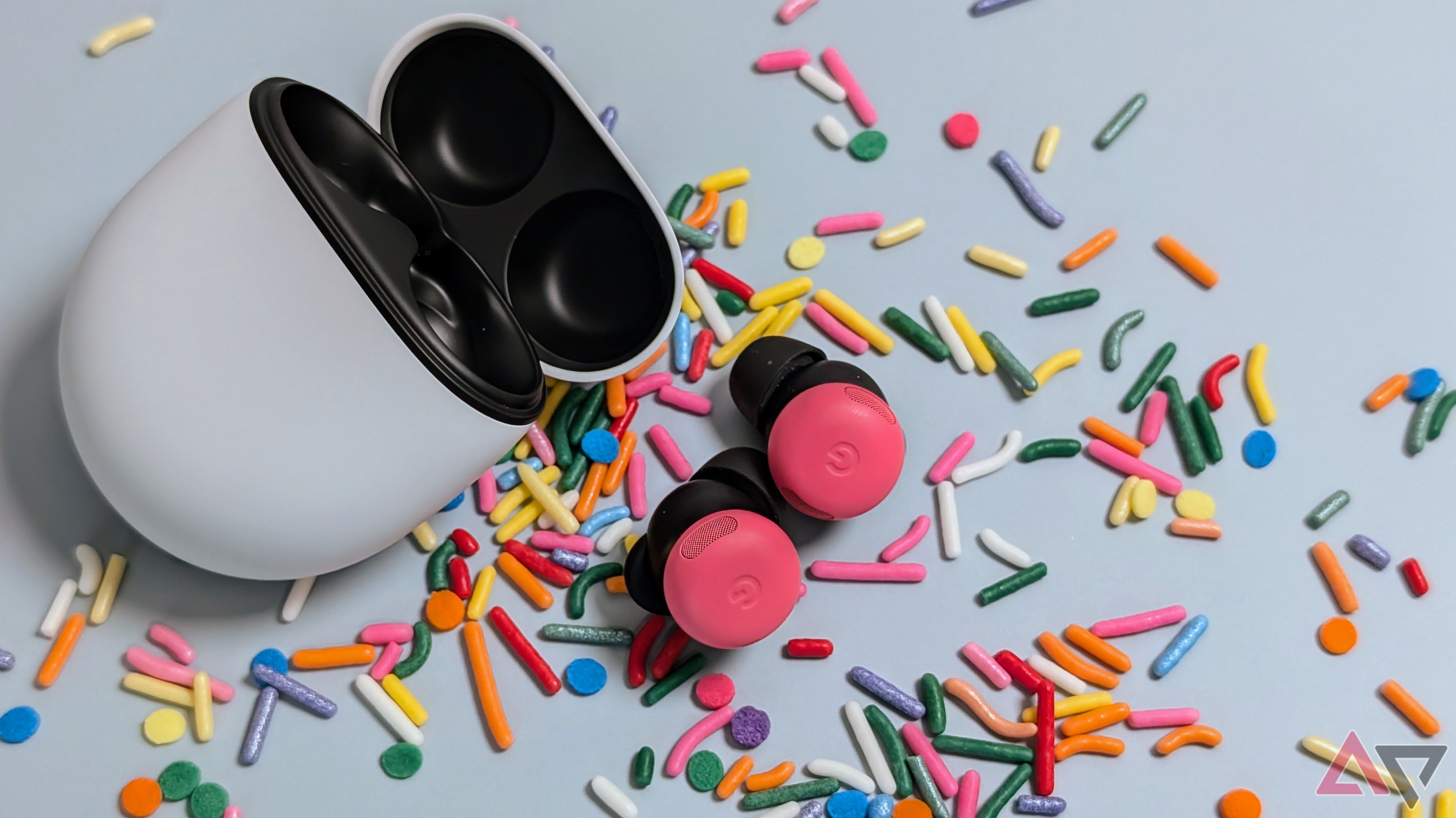 Google Pixel Buds Pro 2 open case with peony buds on table surrounded by sprinkles