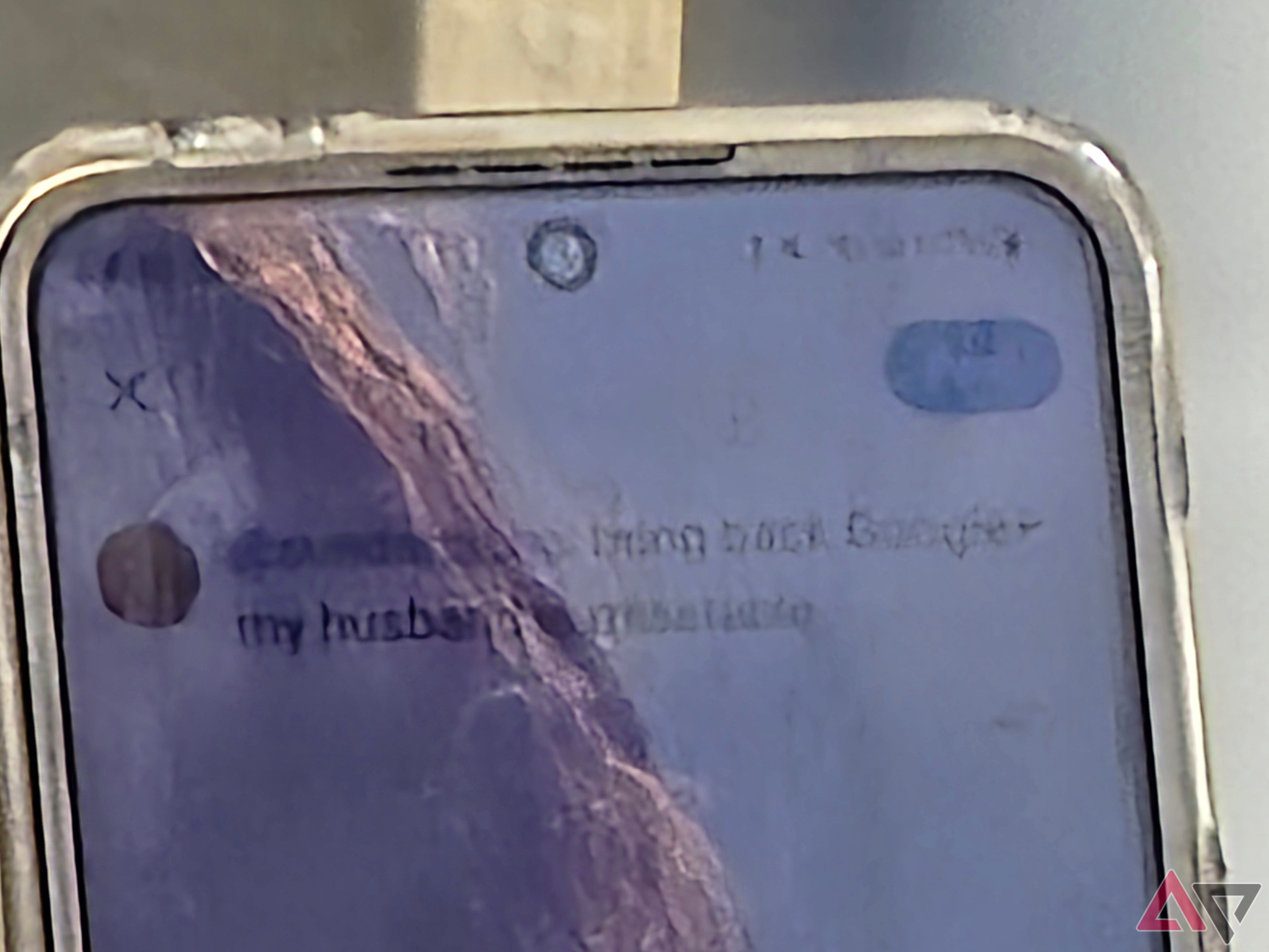 A photo of a woman holding a Galaxy Z Flip 5, the photo is zoomed in and lacks detail