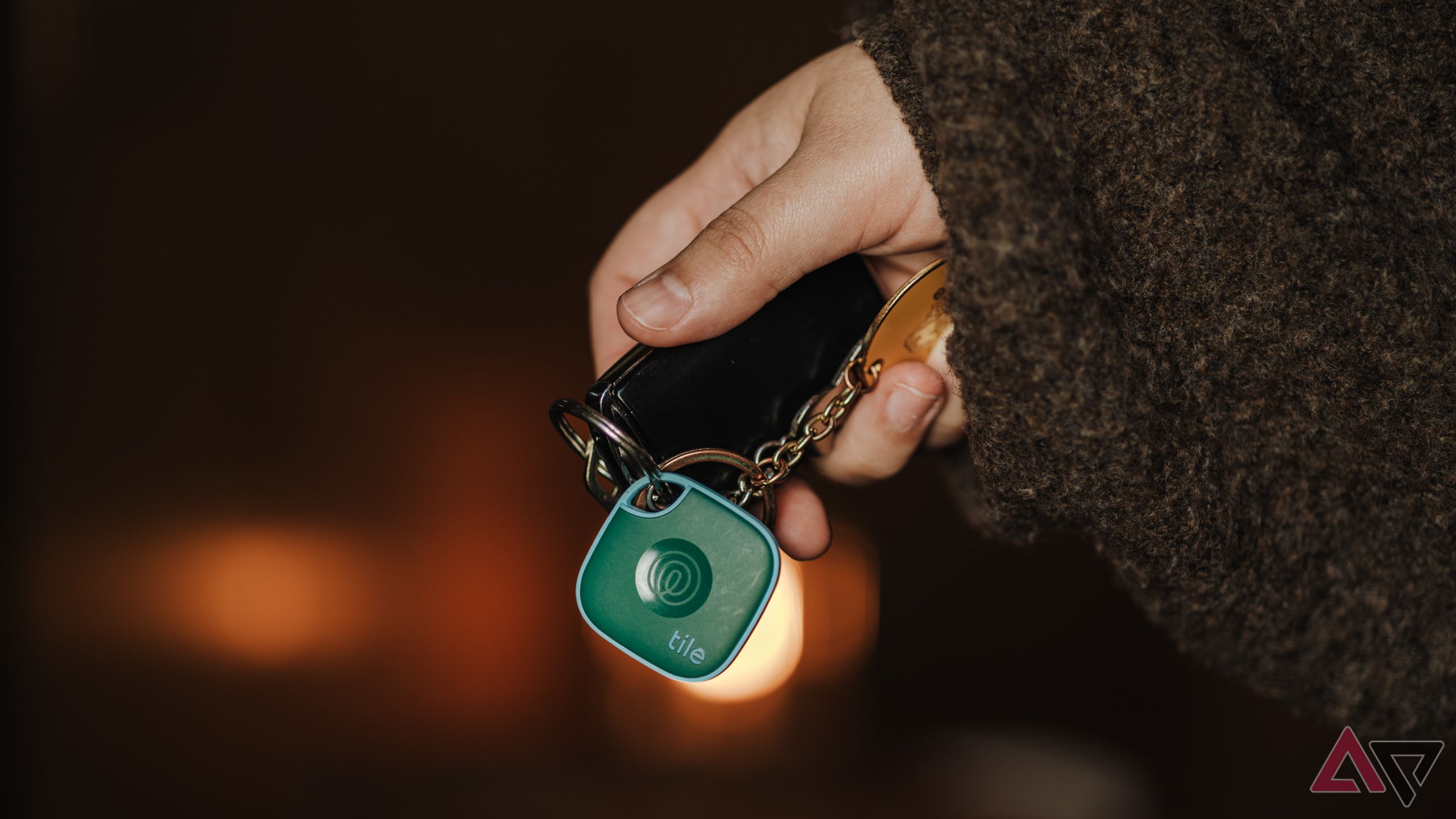 Person holding Ford car keys with 2024 Tile Mate in green