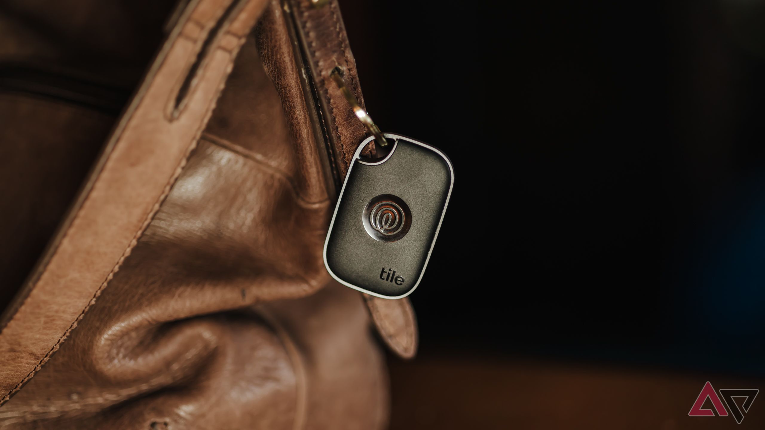 The Tile 2024 Bluetooth tracker on brown leather bag