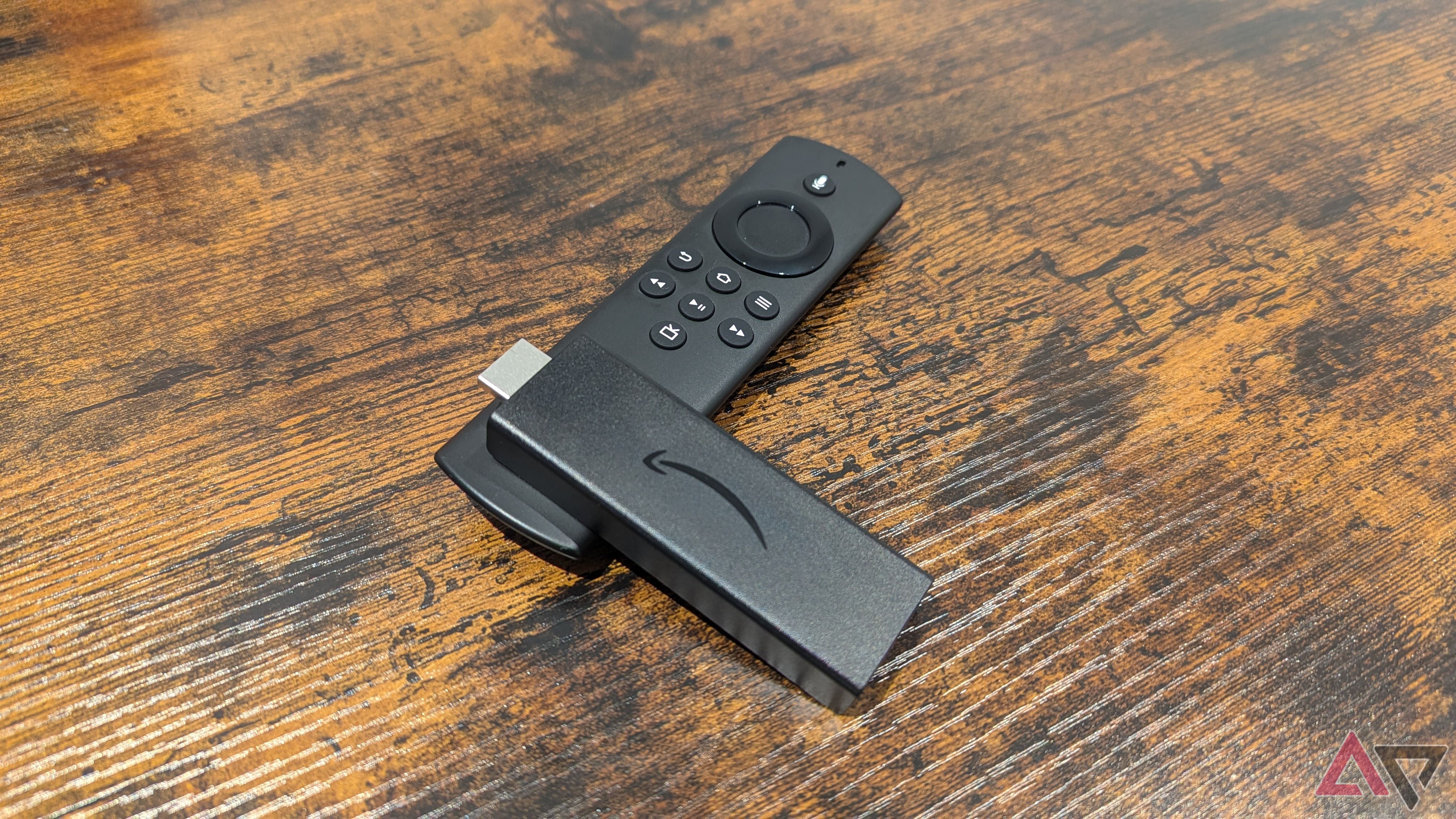 Amazon Fire TV Stick Lite nằm trên Alexa Voice Remote Lite trên bàn gỗ