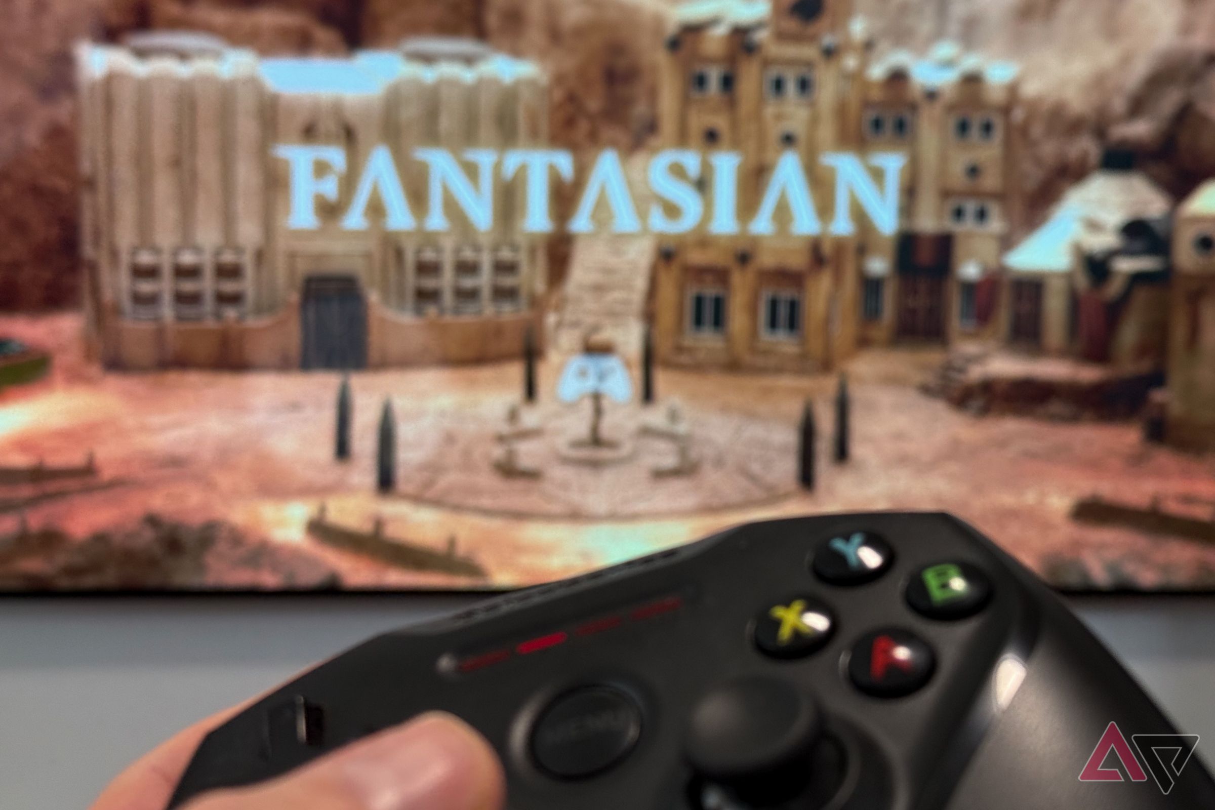 Nimbus Game Controller being held in front of Fantasian running on an Apple TV 4K