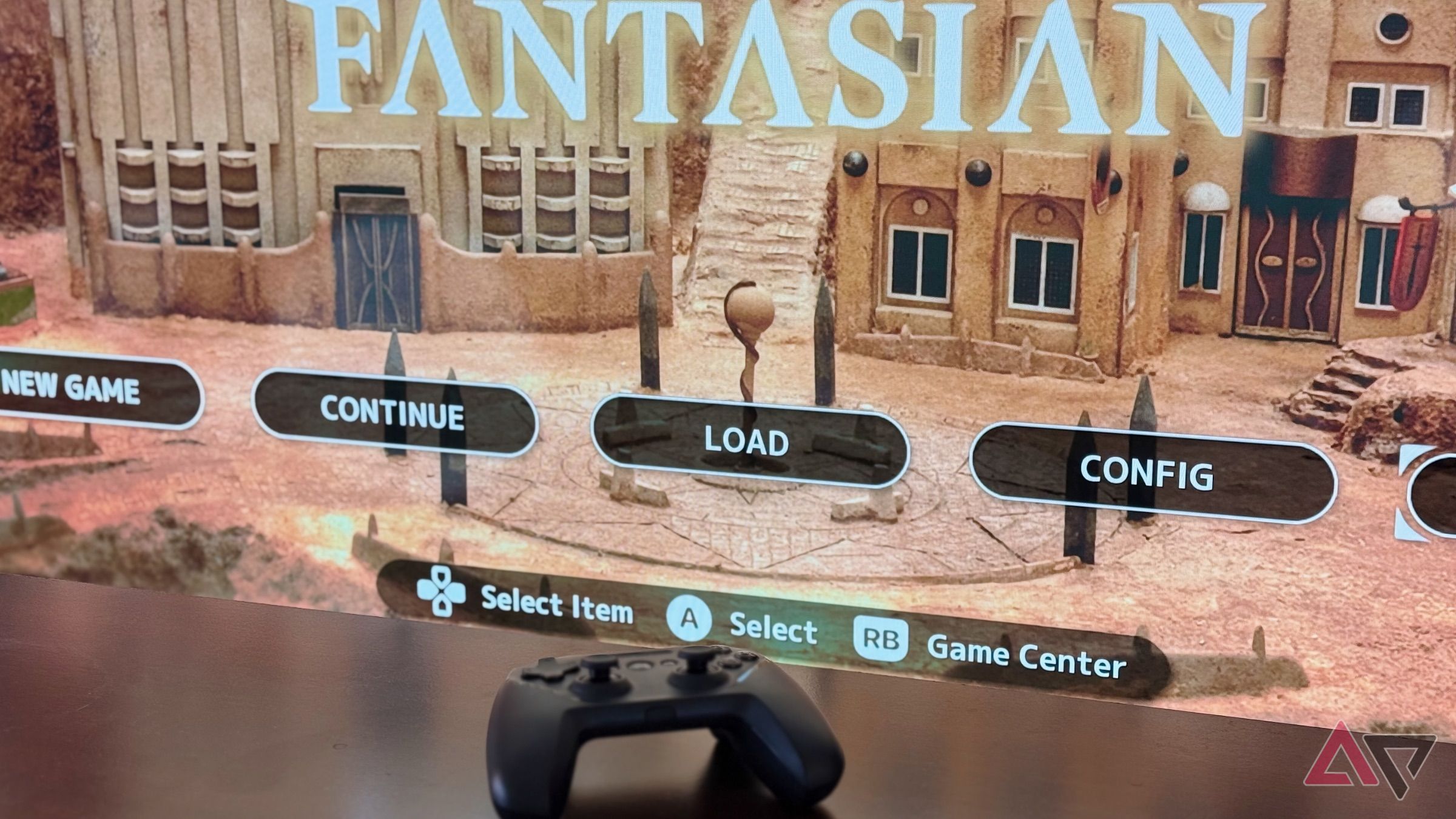 Nimbus Game Controller laying on a wooden table in front of a TV showing the Apple TV game Fantasian. 