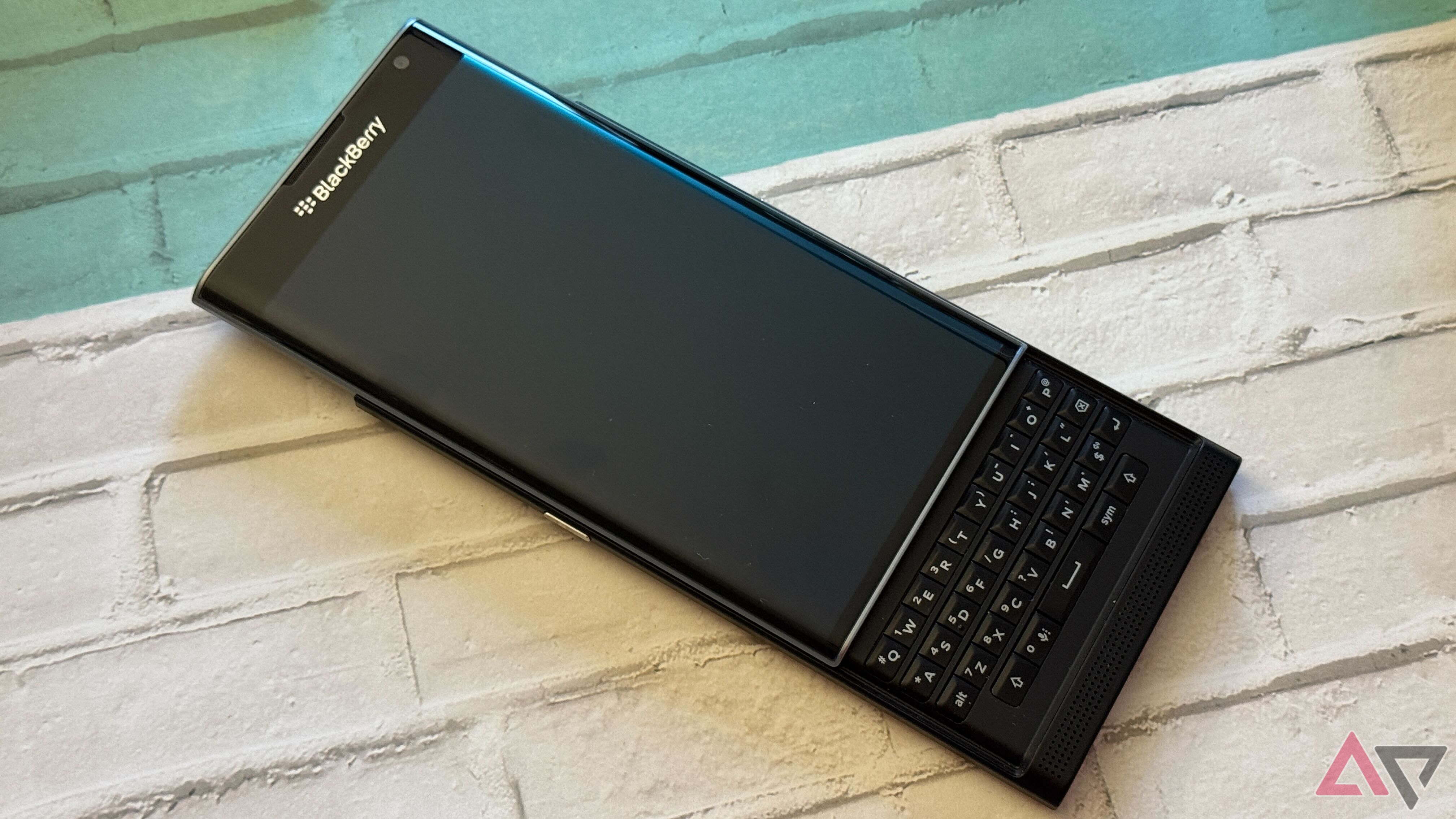 BlackBerry Priv placed on a brick with keyboard slid out and screen removed