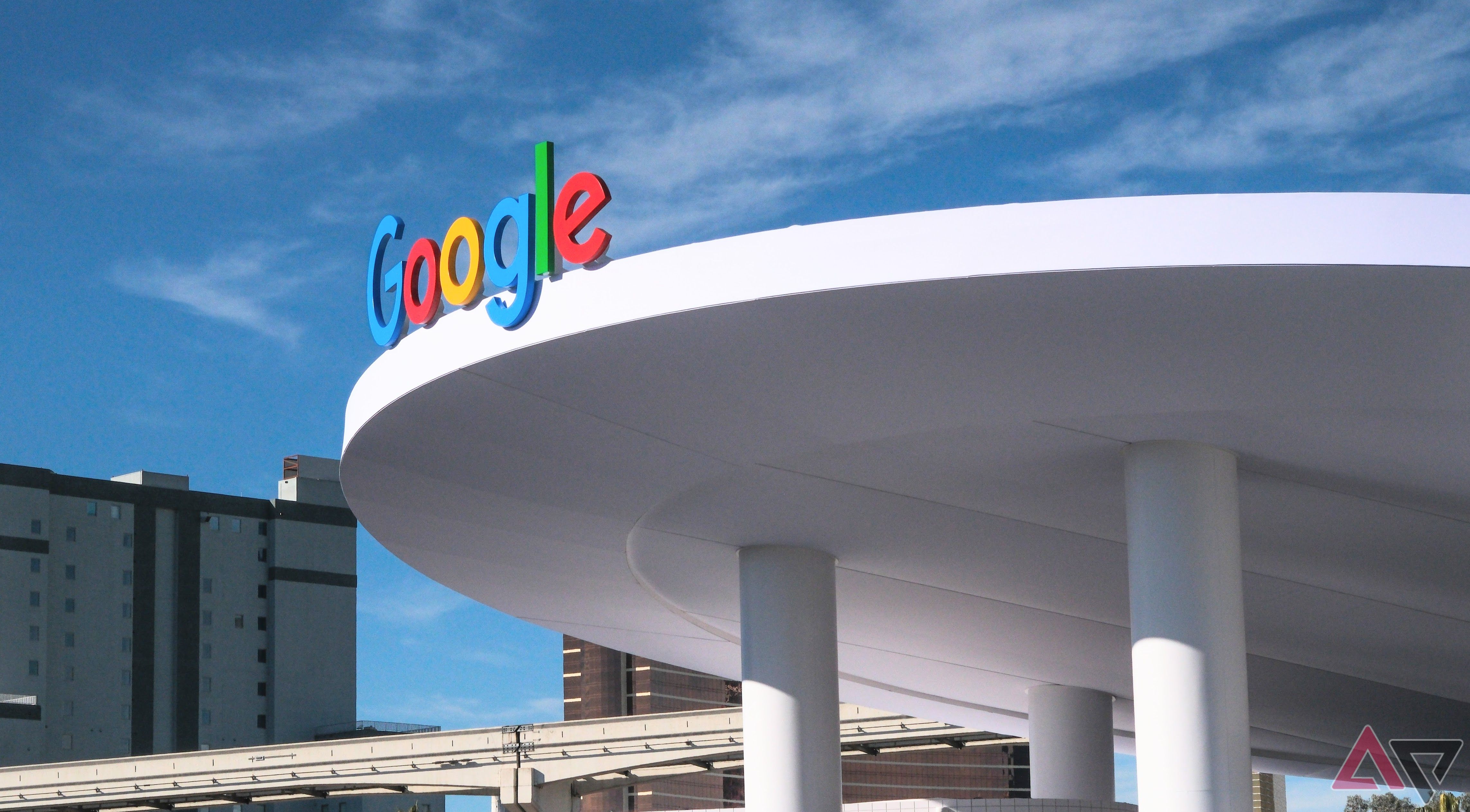 A Google sign on a round awning in a city setting. 