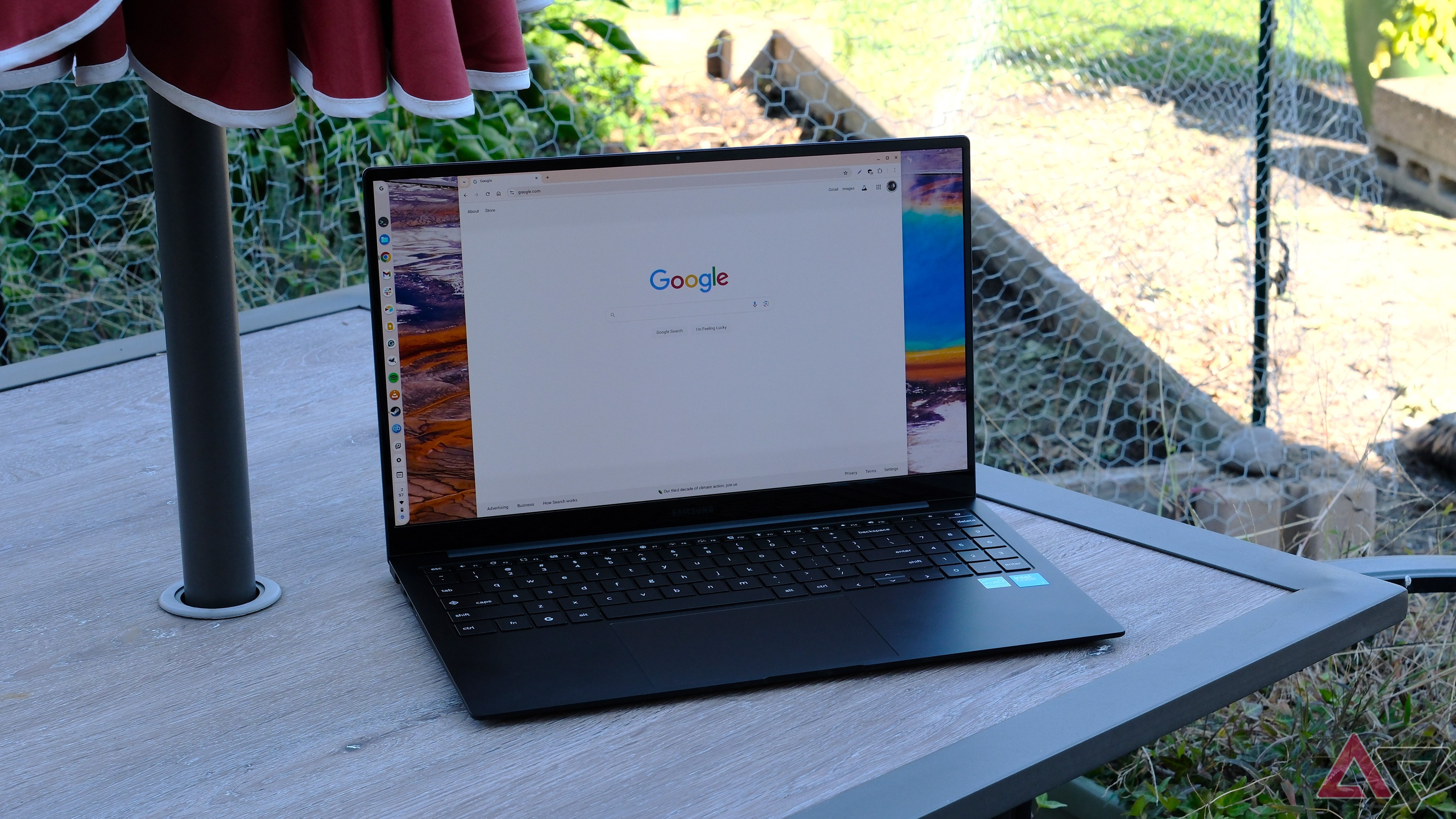 Samsung Chromebook Plus on table with lid open and screen on