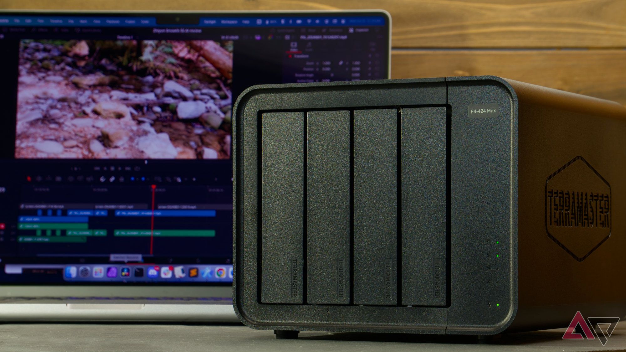 TerraMaster F4-424 Max with laptop in the background showing a video editing timeline