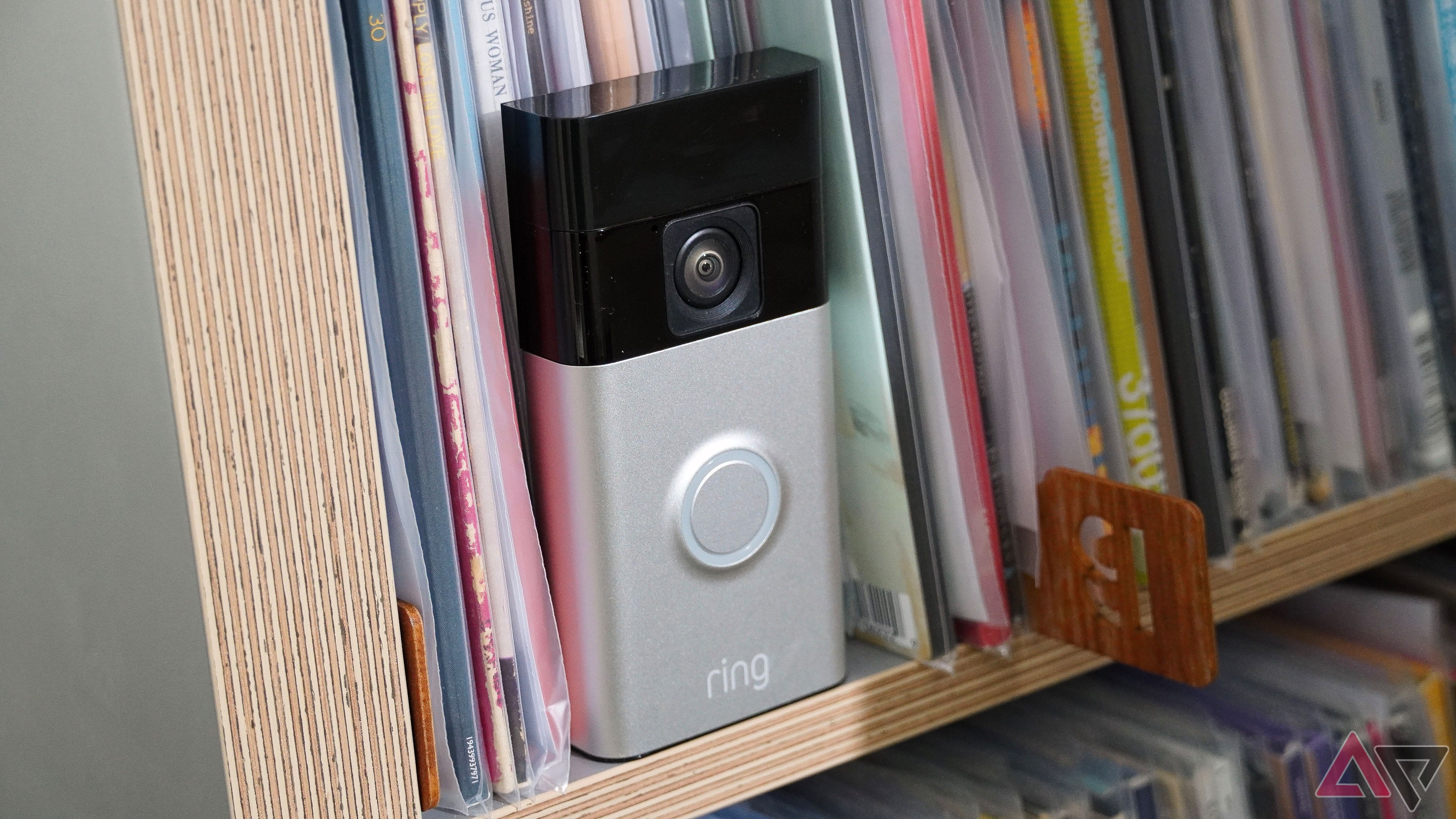 The Ring Battery Doorbell leaning against records.