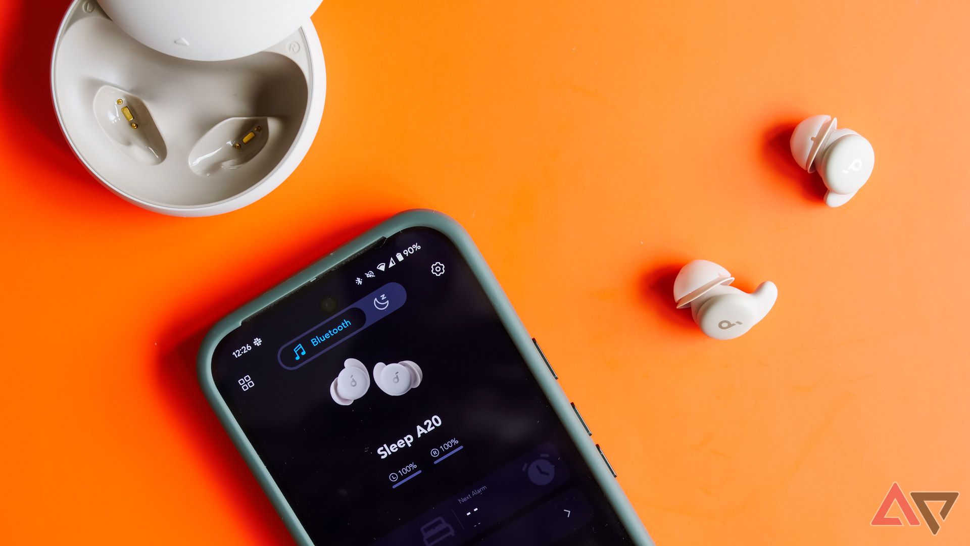 The Anker Soundcore Sleep A20 earbuds next to a Pixel 9 Pro with the app open.