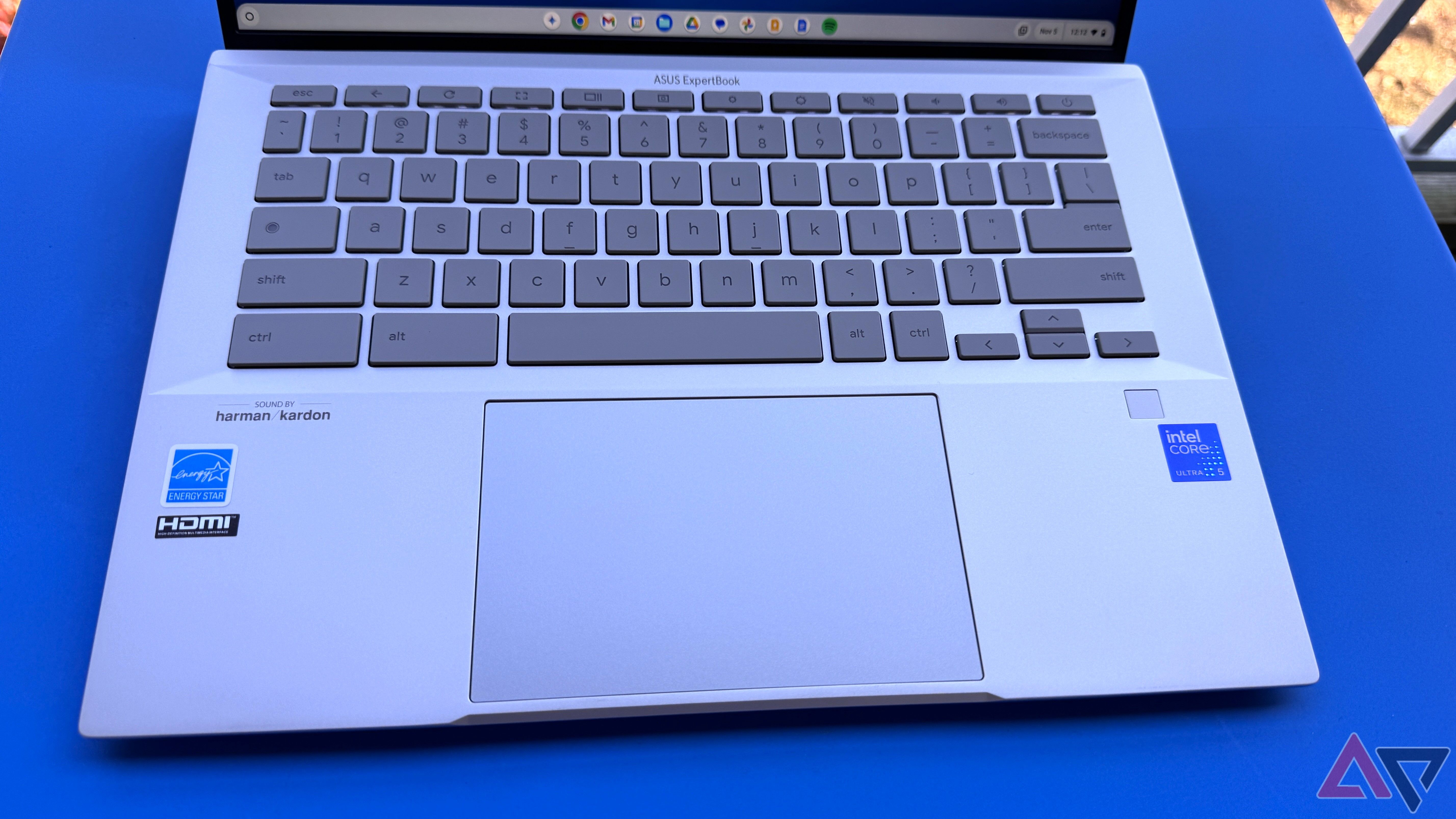 Asus Chromebook Plus CX54 Keyboard and Trackpad on a blue table.