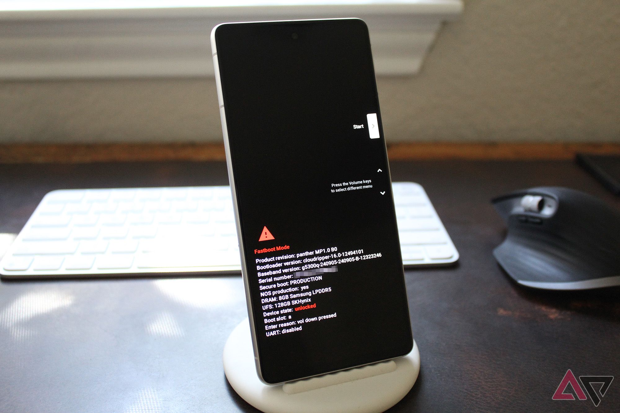 A Pixel 7 on a desk with its Fastboot mode screen visible, showing an unlocked bootloader.