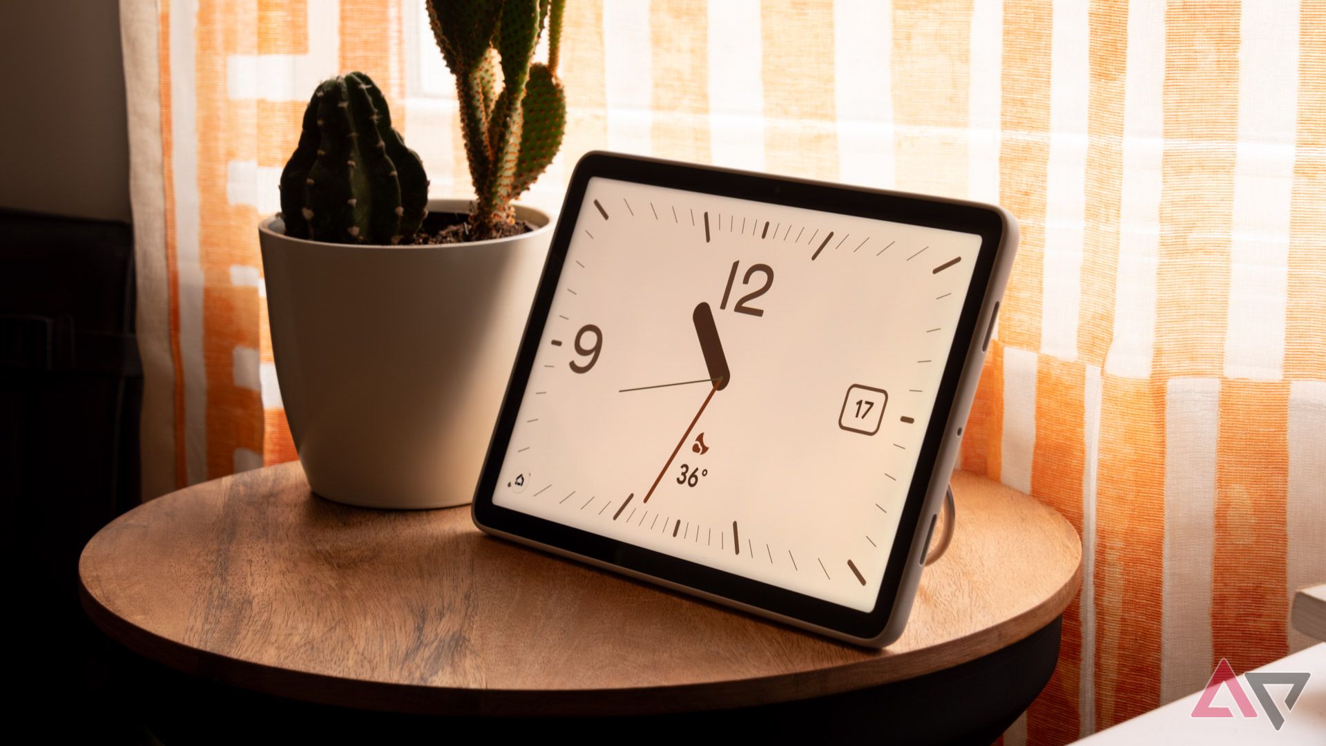 The Google Pixel Tablet showing the Pilot Bold clock screen saver.