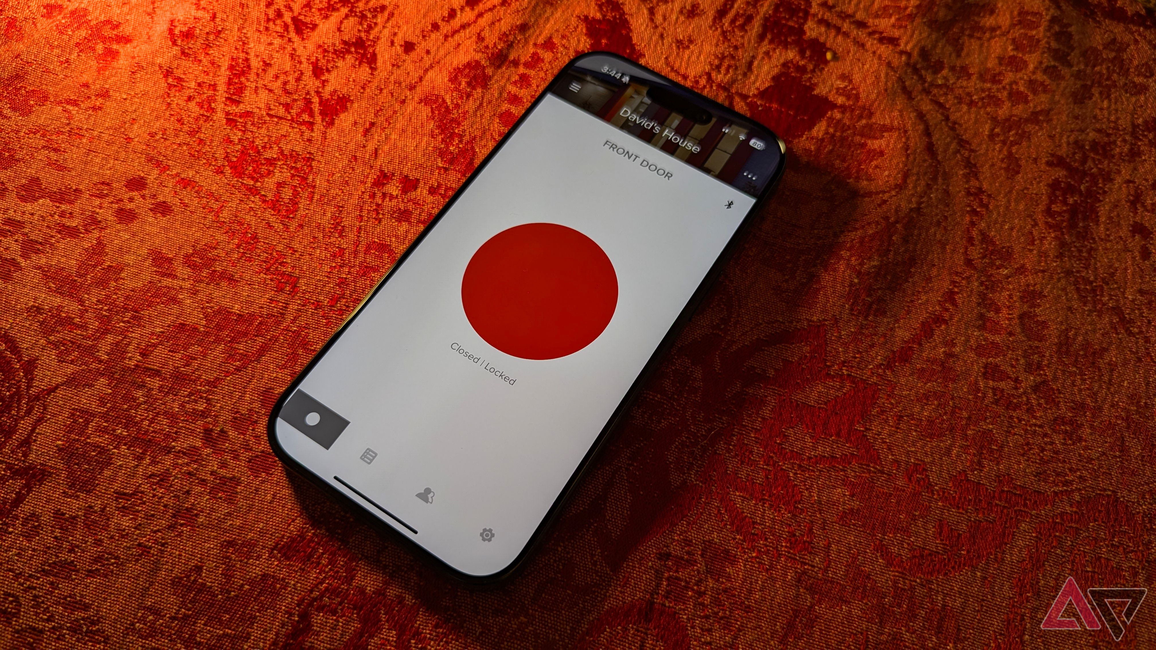 The iPhone 16 Pro on a red background