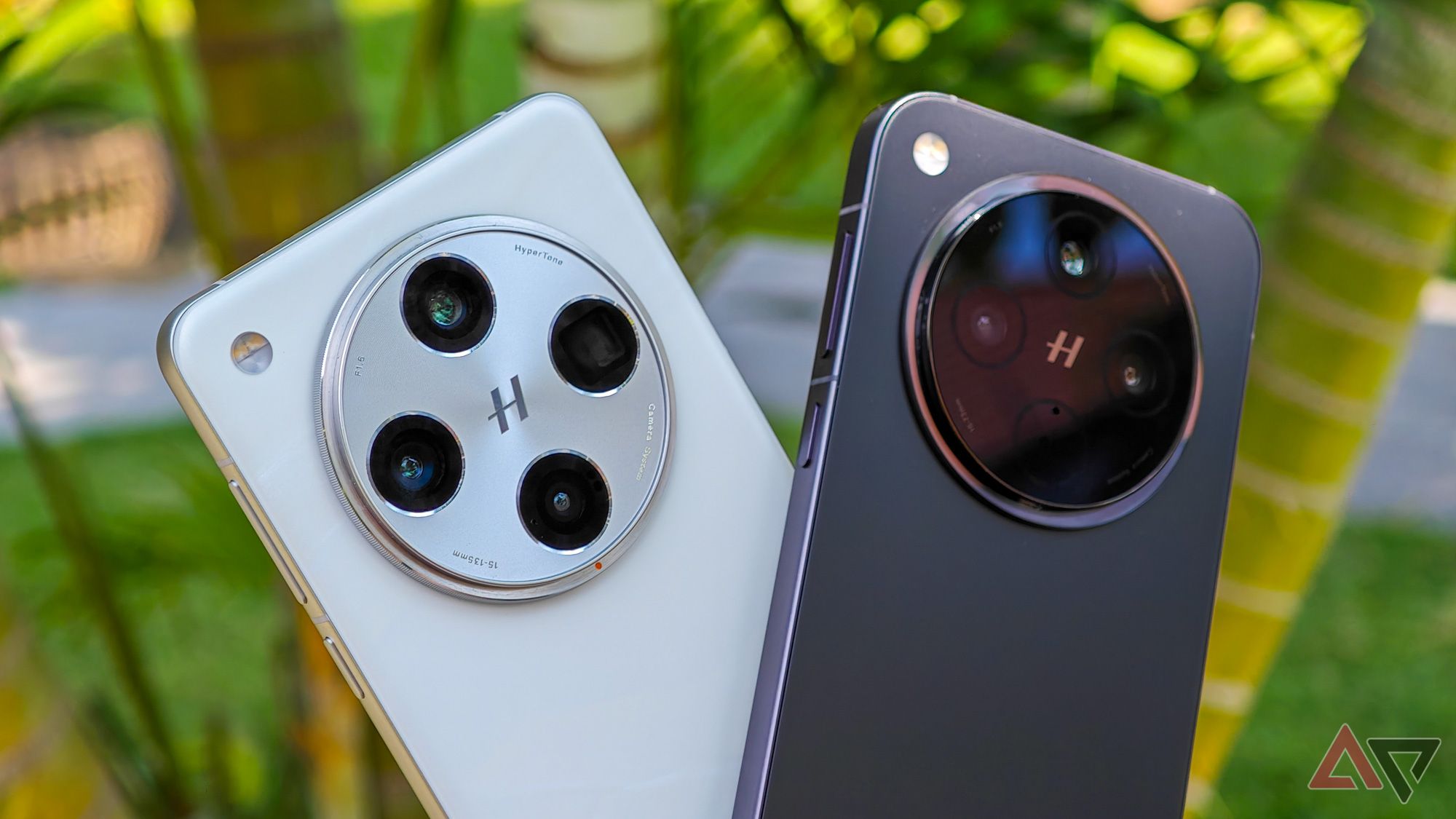 Oppo Find X8 Pro in white with Find X8 in black, against green plants in background