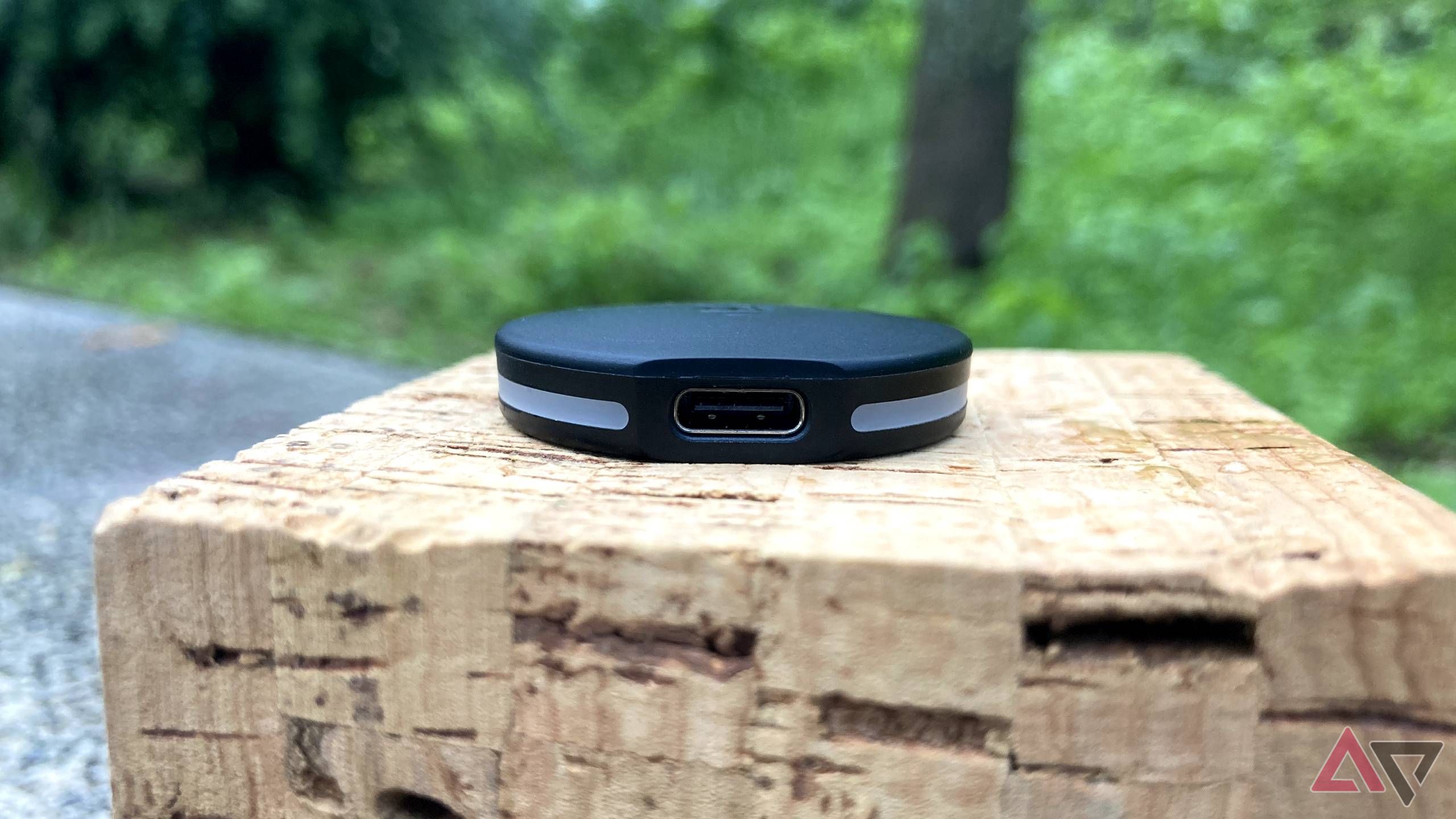 The Pebblebee Clip Universal on a block of cork outdoors