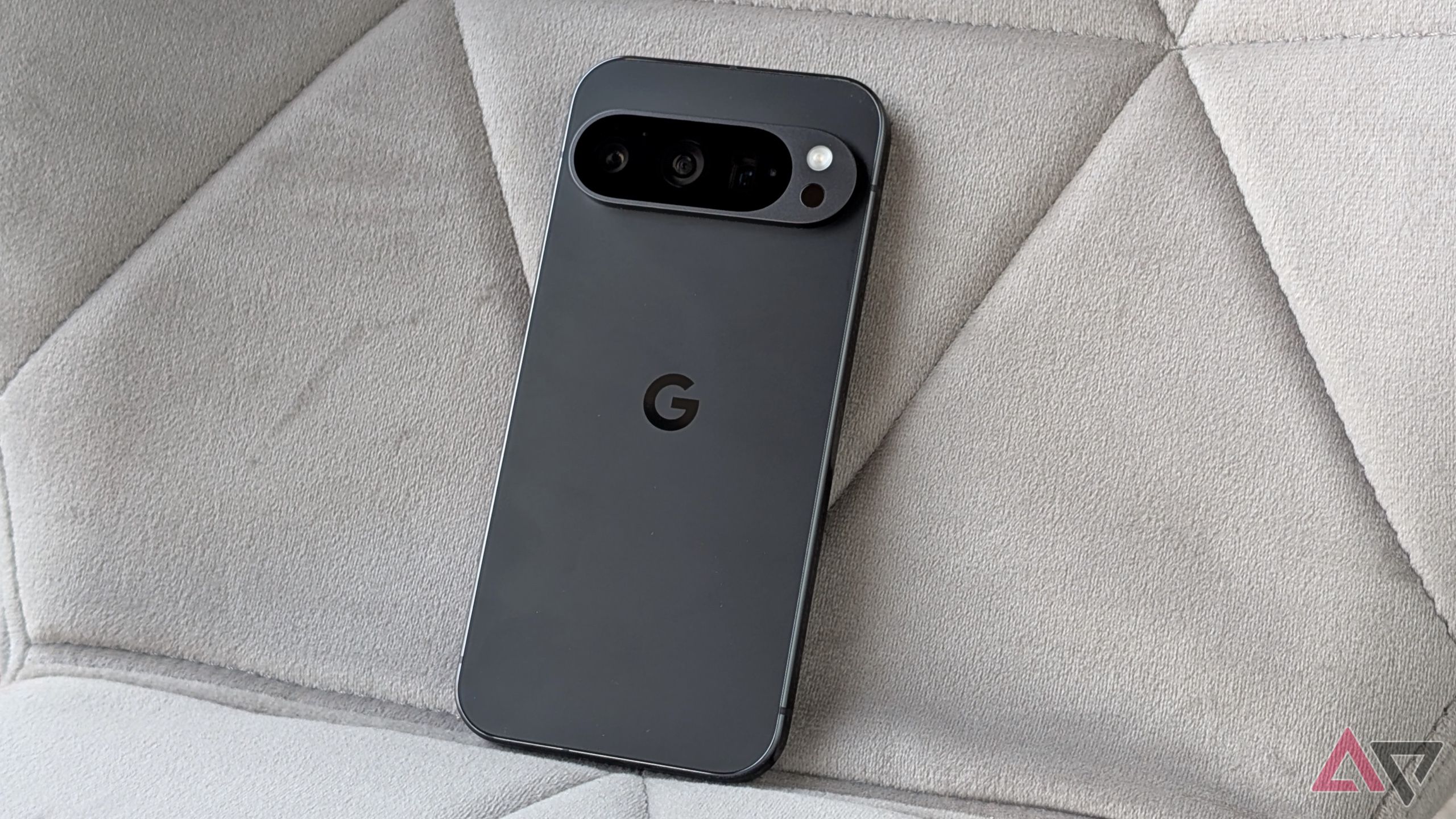 Pixel 9 Pro laying on a gray chair