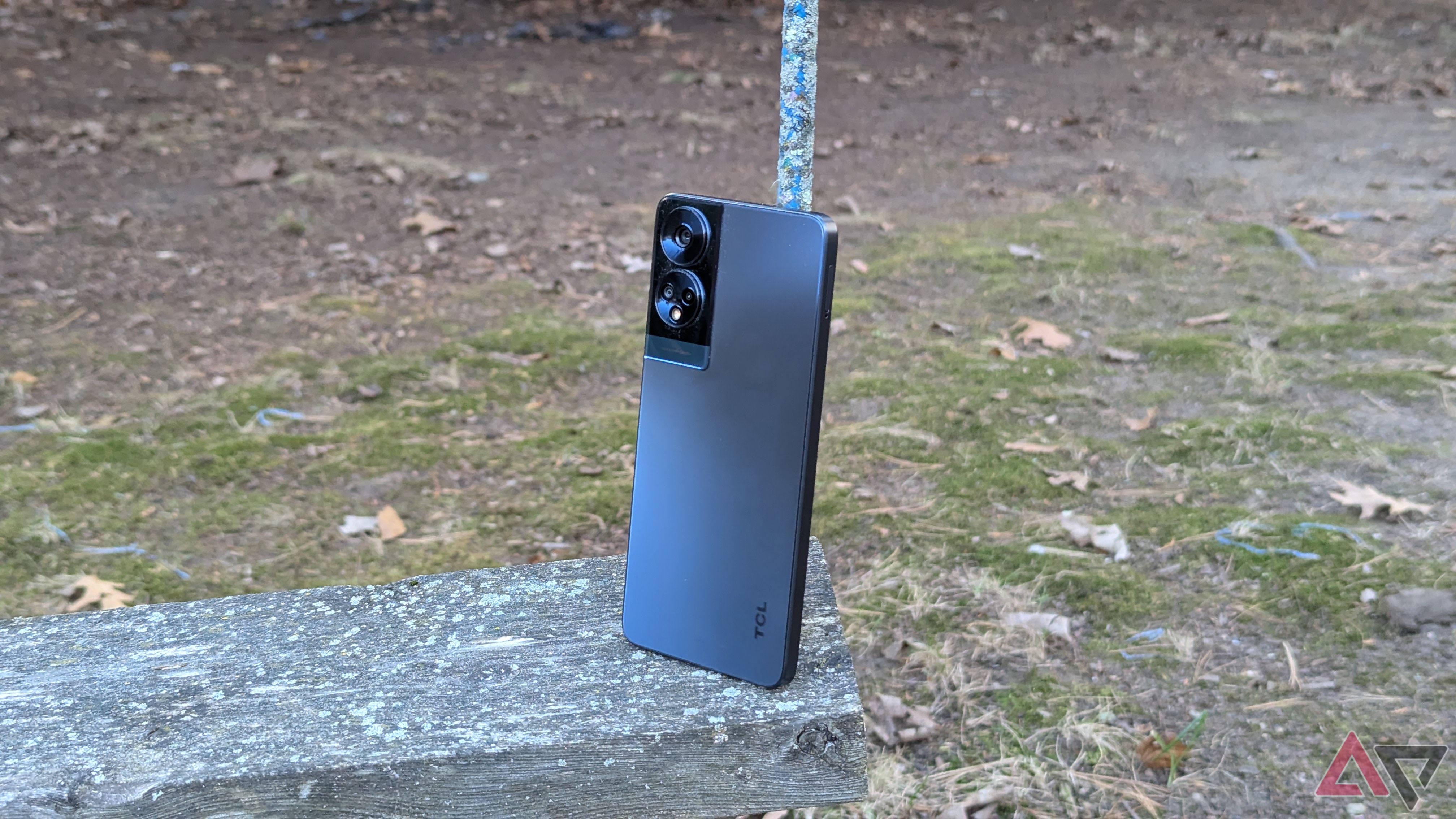 A TCL 50 XE NXTPAPER 5G sitting on a swing with the back visible