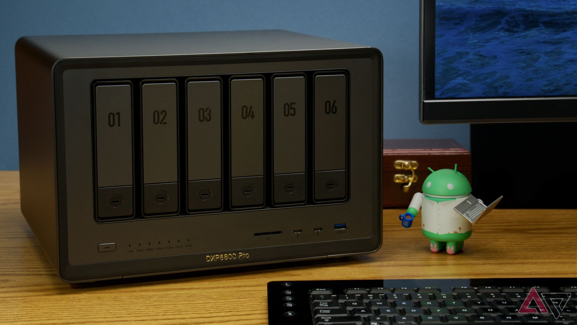 Ugreen DXP6800 Pro on a desk next to an Android figurine and other typical objects