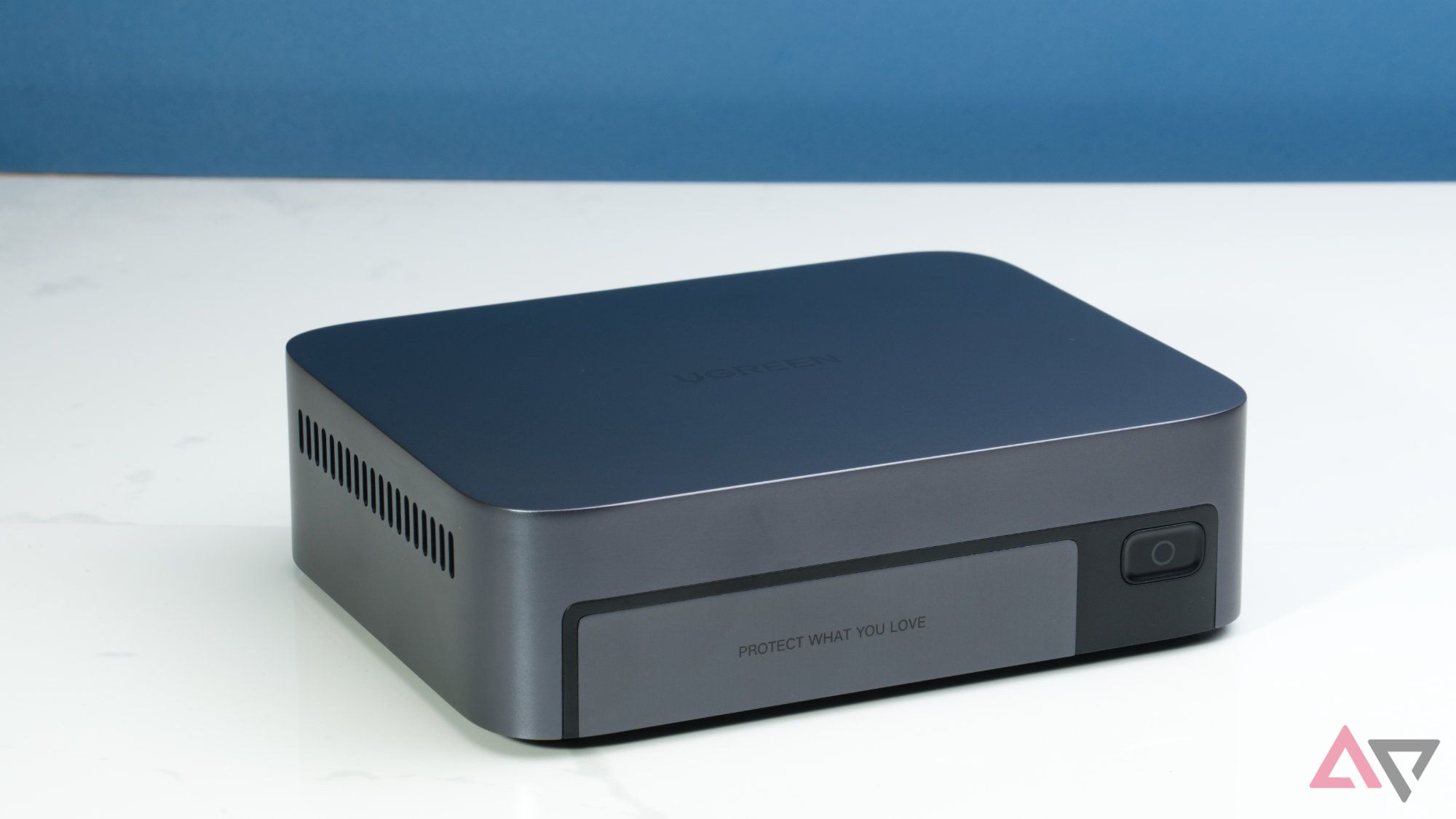 Ugreen NASync DXP480T Plus on a white surface with a blue background
