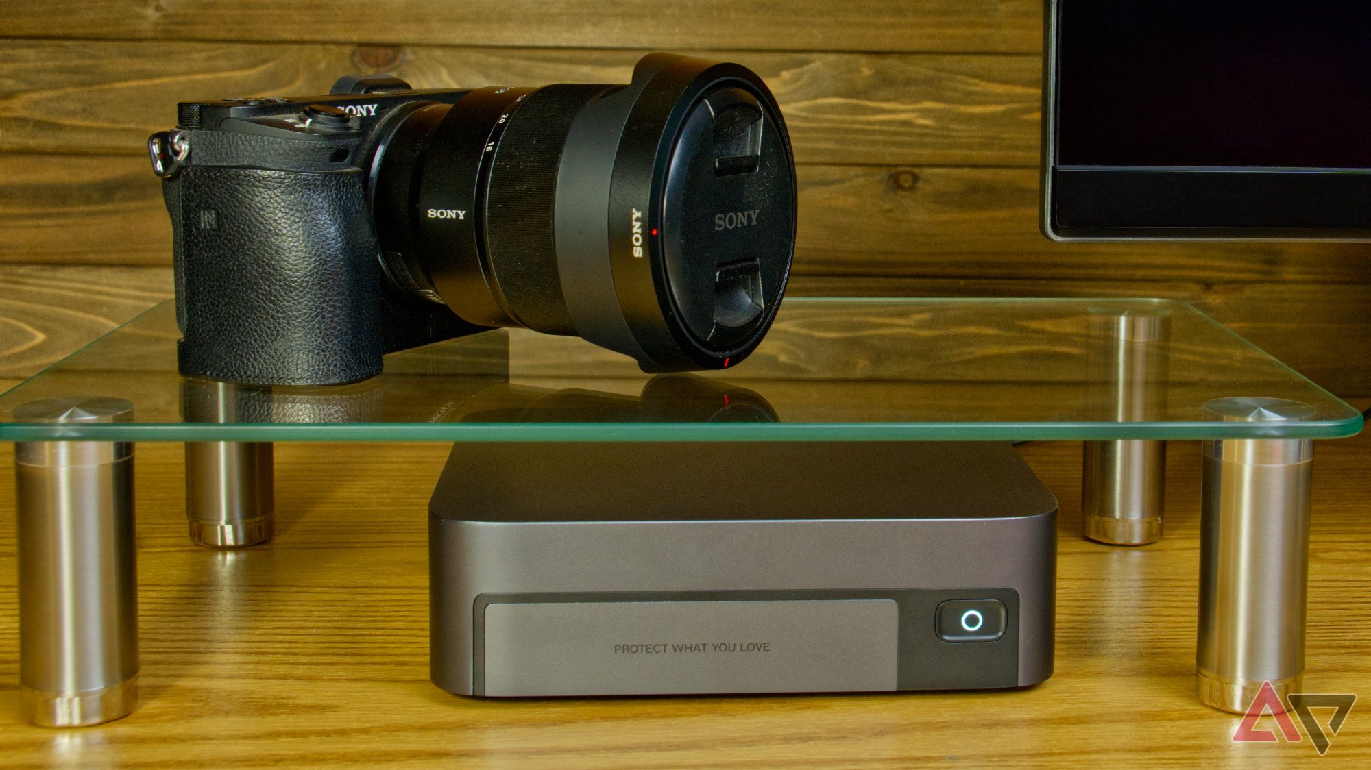 Ugreen NASync DXP480T Plus under a glass shelf with a camera above it