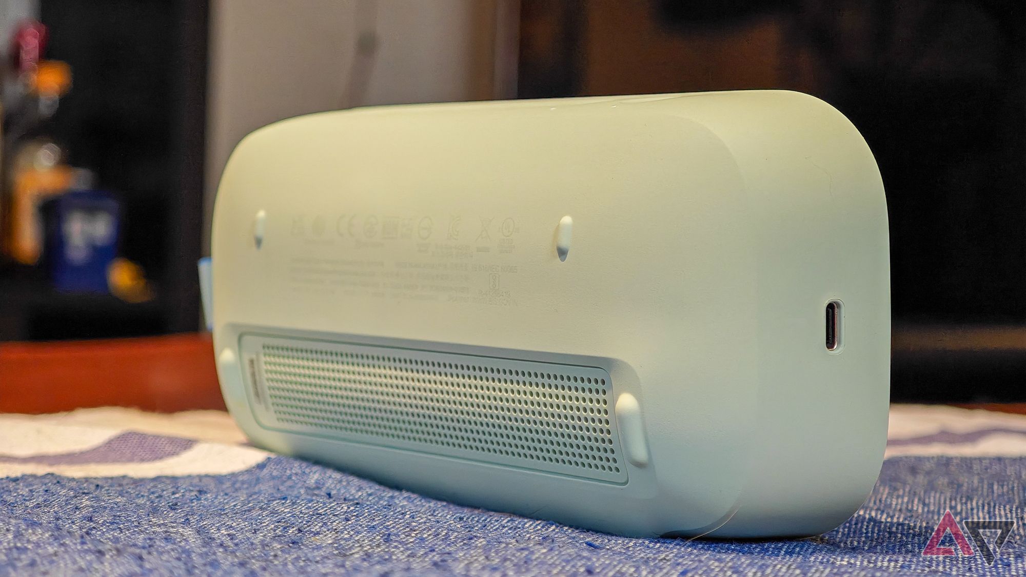 Bose SoundLink Flex 2 speaker seen from behind on a wooden table