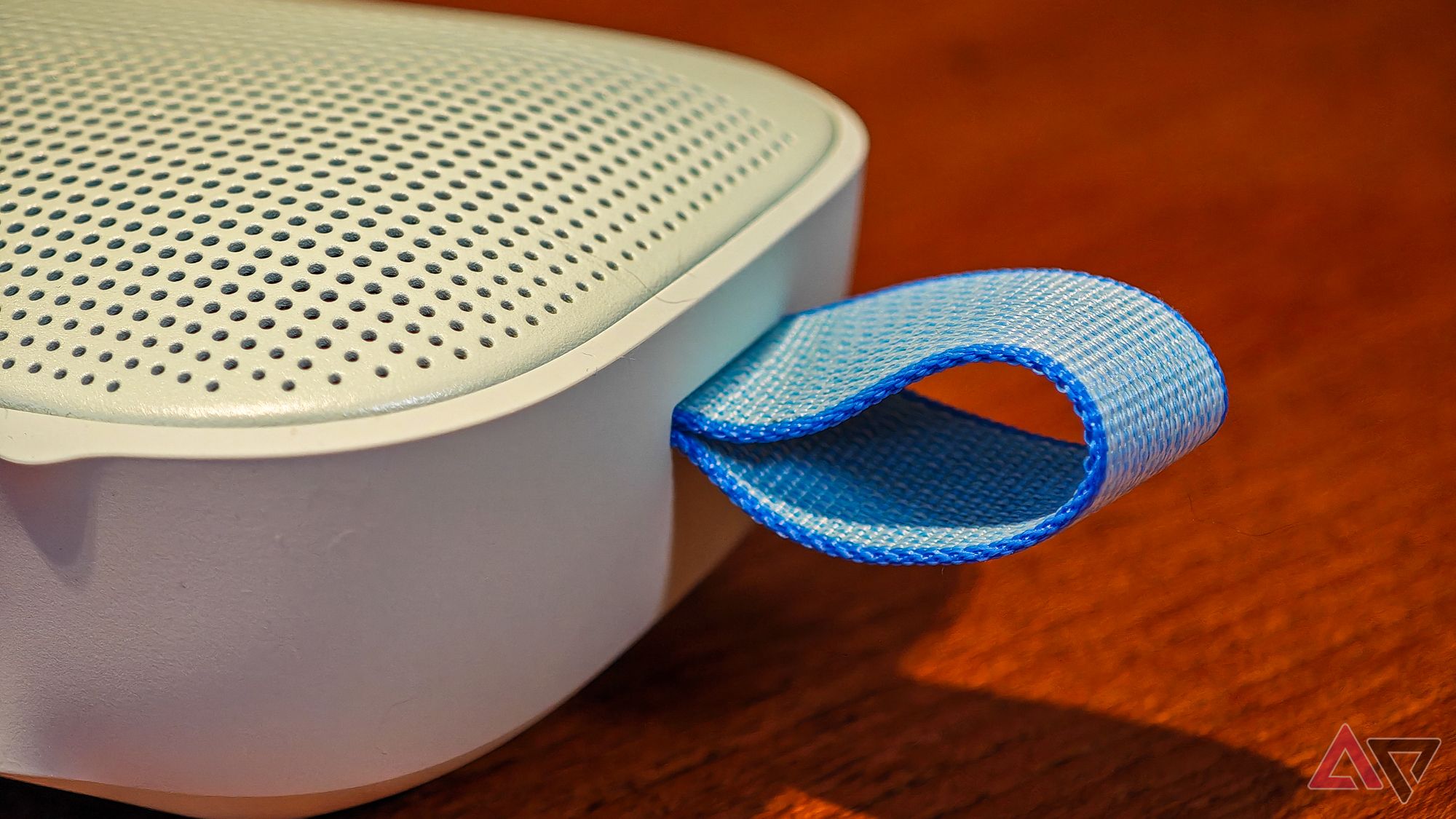 The fabric loop on the end of the Bose SoundLink Flex 2 speaker on a wooden table