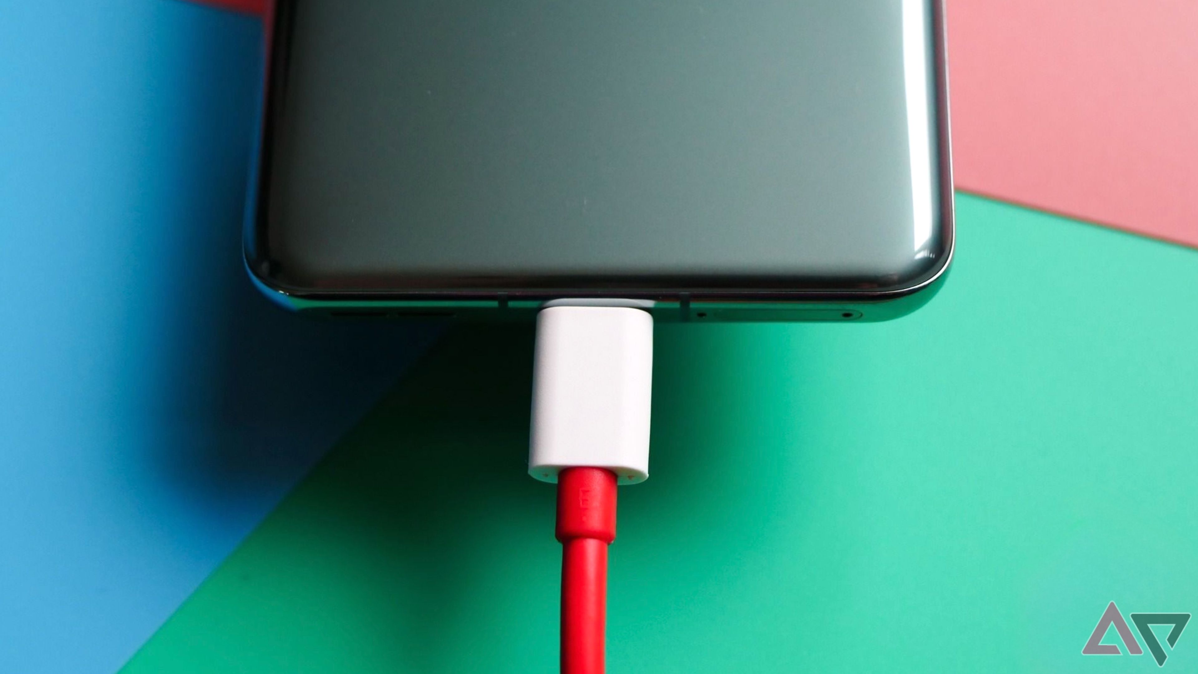 OnePlus 11 connected to a red USB C cable